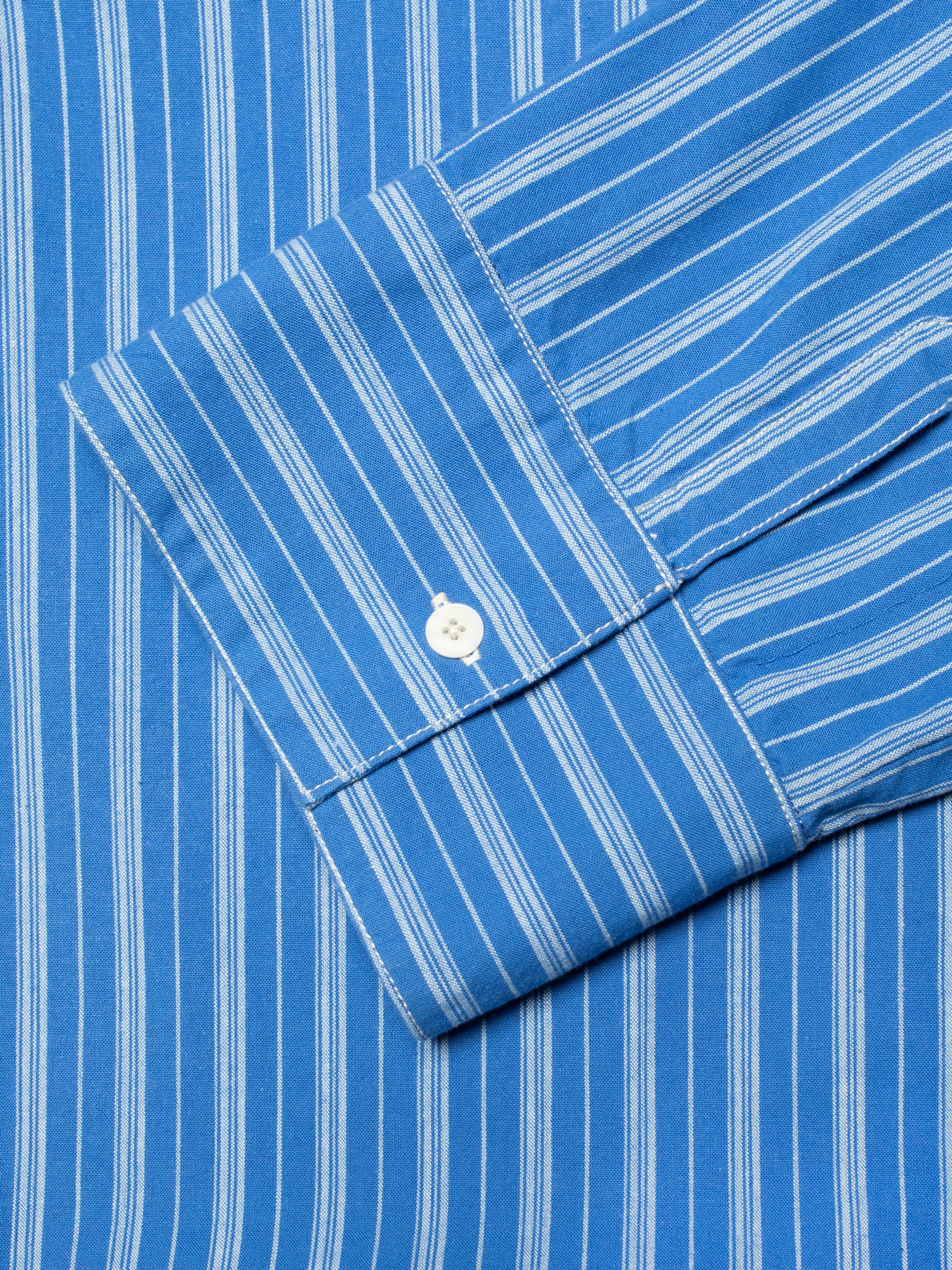 Nudie Jeans Jutta Shirt Striped in Blue/Off-white, close-up of the sleeve cuff showing the fabric and corozo button.