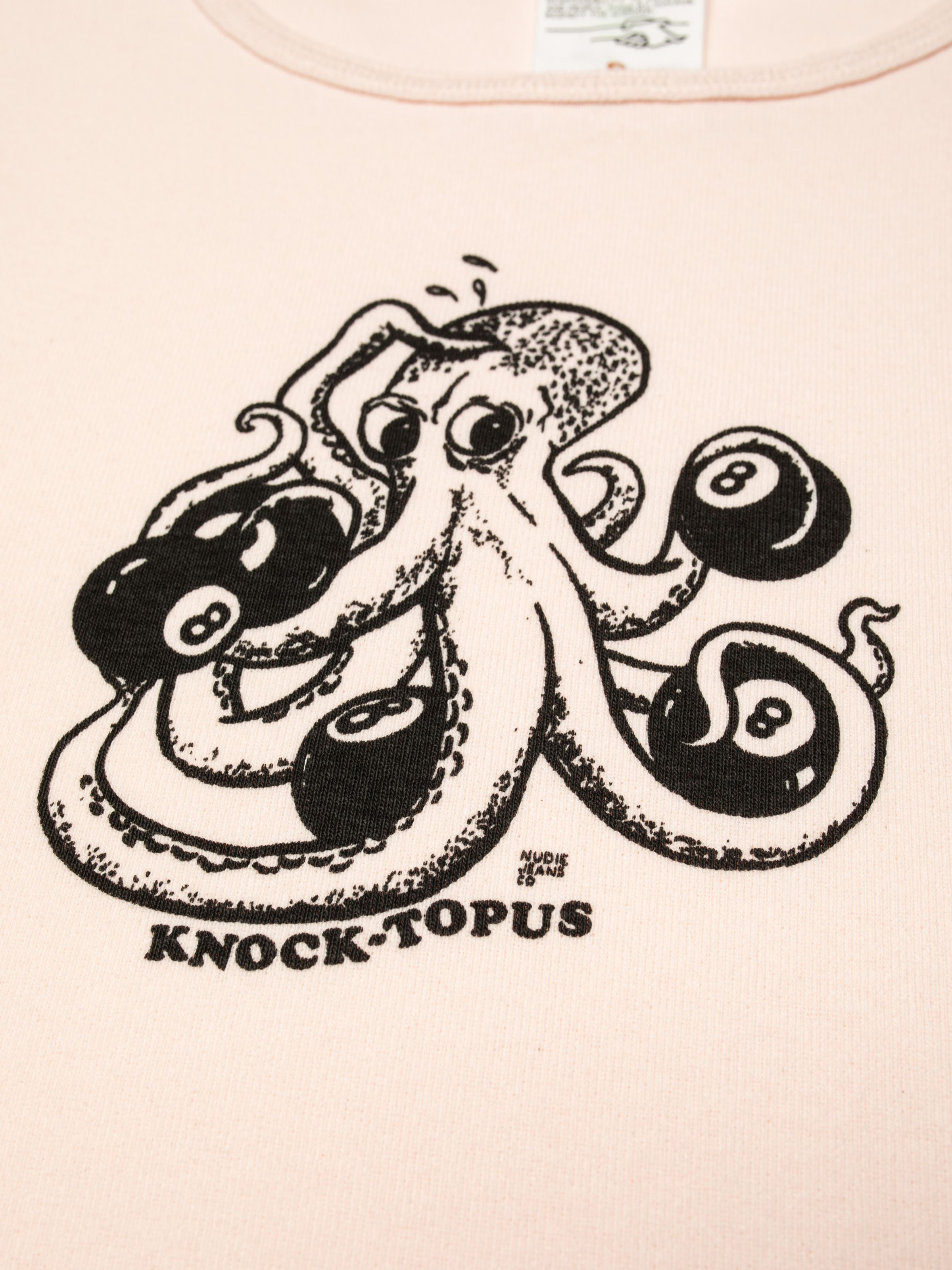 Nudie Jeans Eve T-Shirt Knock-Topus in pink, close-up of the 'Knock-Topus' graphic print on the chest.