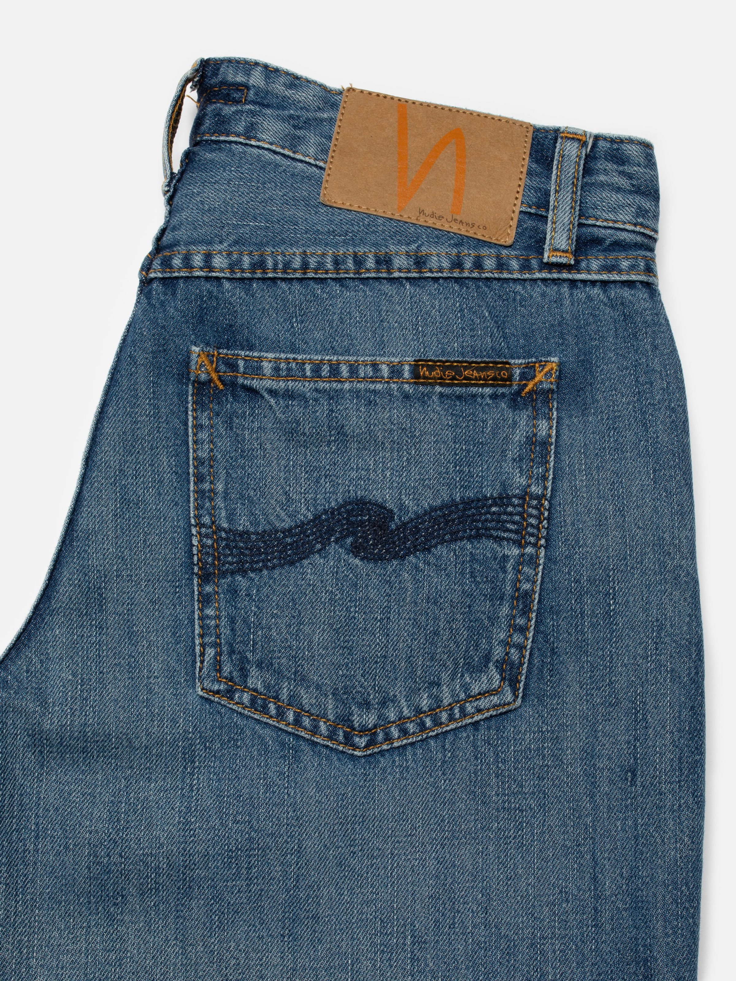 Nudie Jeans Wide Heidi Clear Skies, close-up of the back pocket with navy embroidery and jacron patch.
