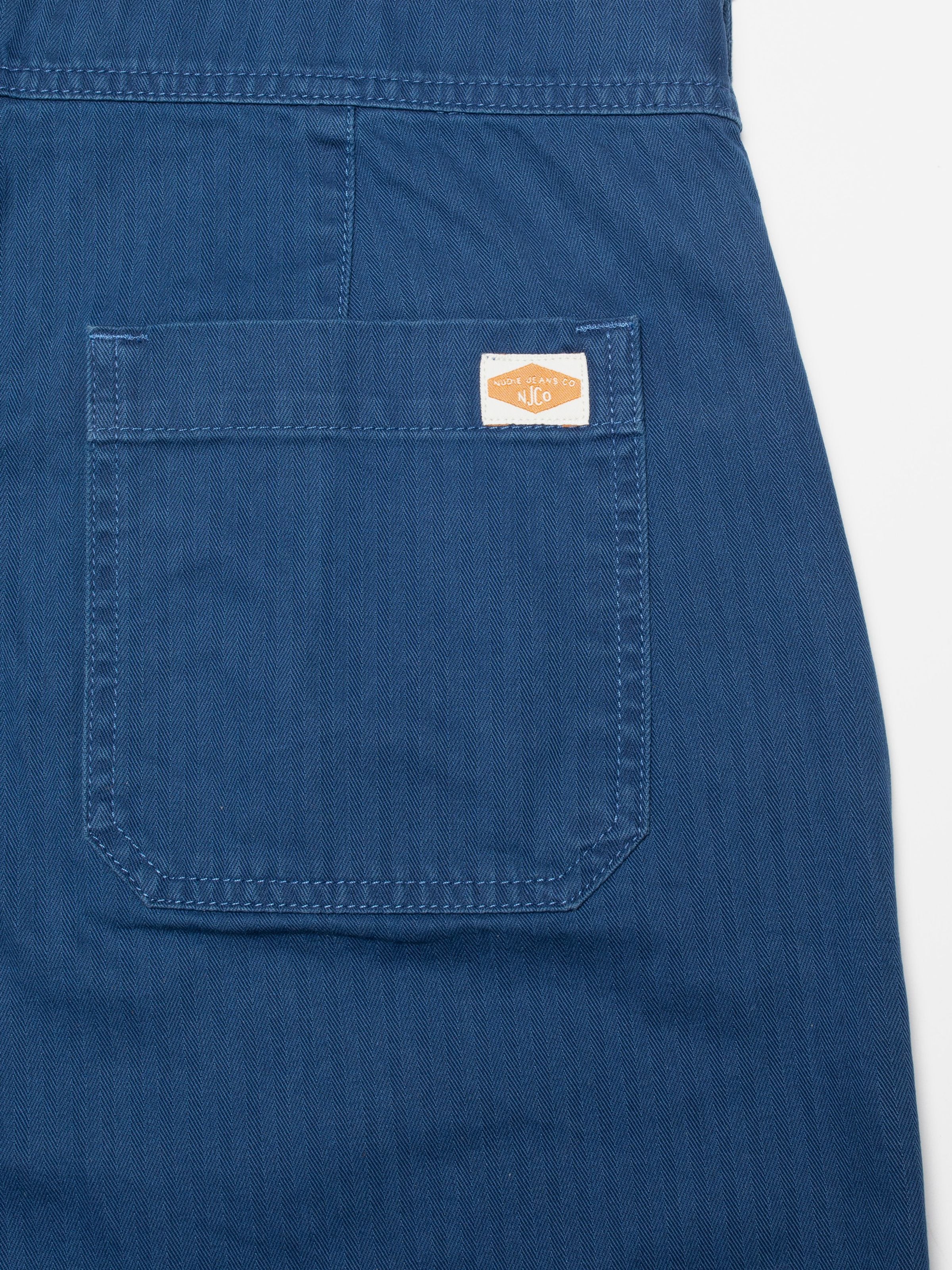 Nudie Jeans Klara Dungarees Herringbone, women's regular fit dungarees, back pocket close-up showing herringbone twill.