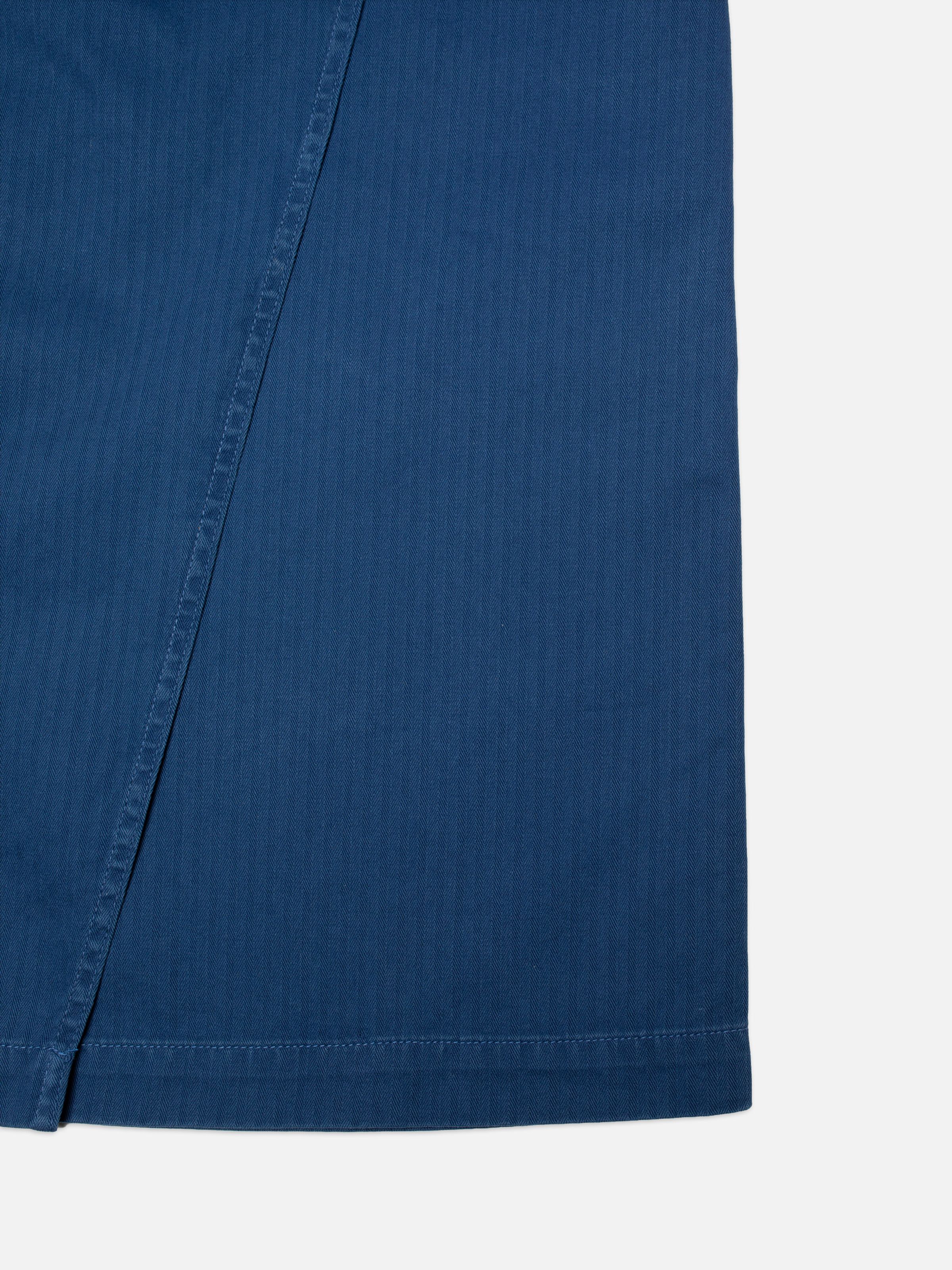 Nudie Jeans Irma Skirt Herringbone, women's blue skirt, showing a close-up of the herringbone twill fabric detail.
