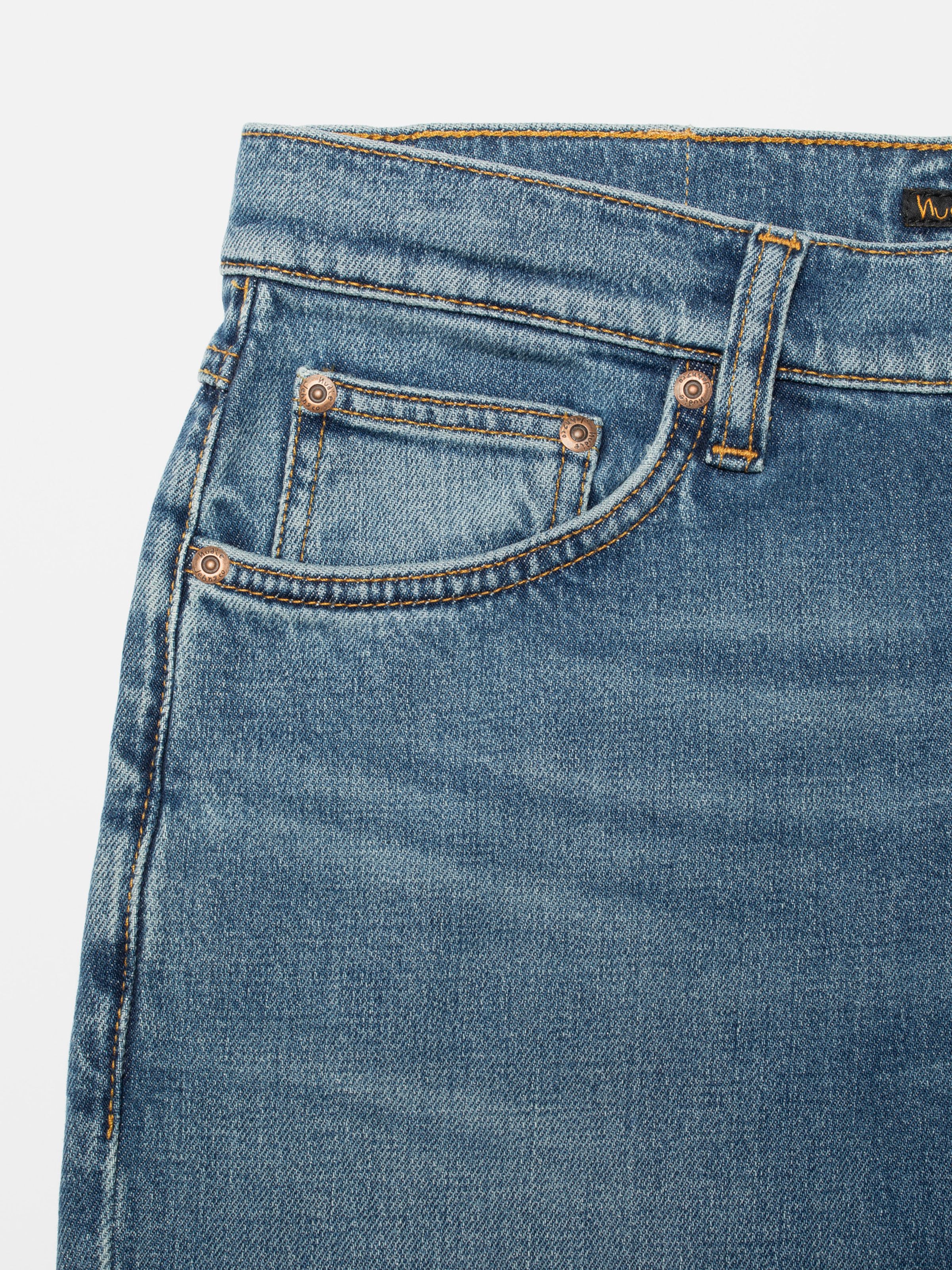 Nudie Jeans Solid Ollie Blue Blur, men's slim fit jeans, with a close-up view of the front coin pocket and waistband.