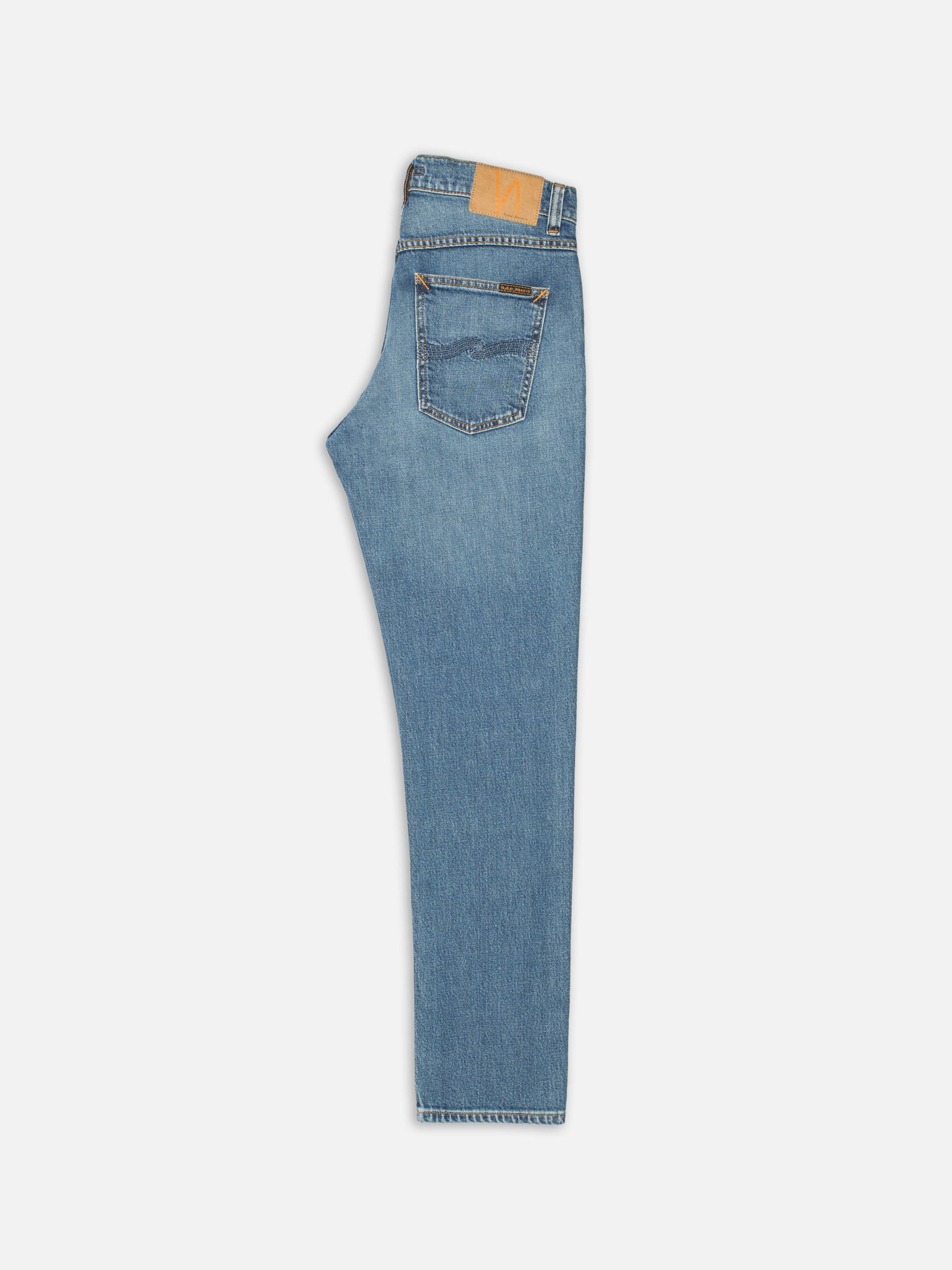 Nudie Jeans Solid Ollie Blue Blur, men's slim fit straight leg jeans, shown folded flat from the back.