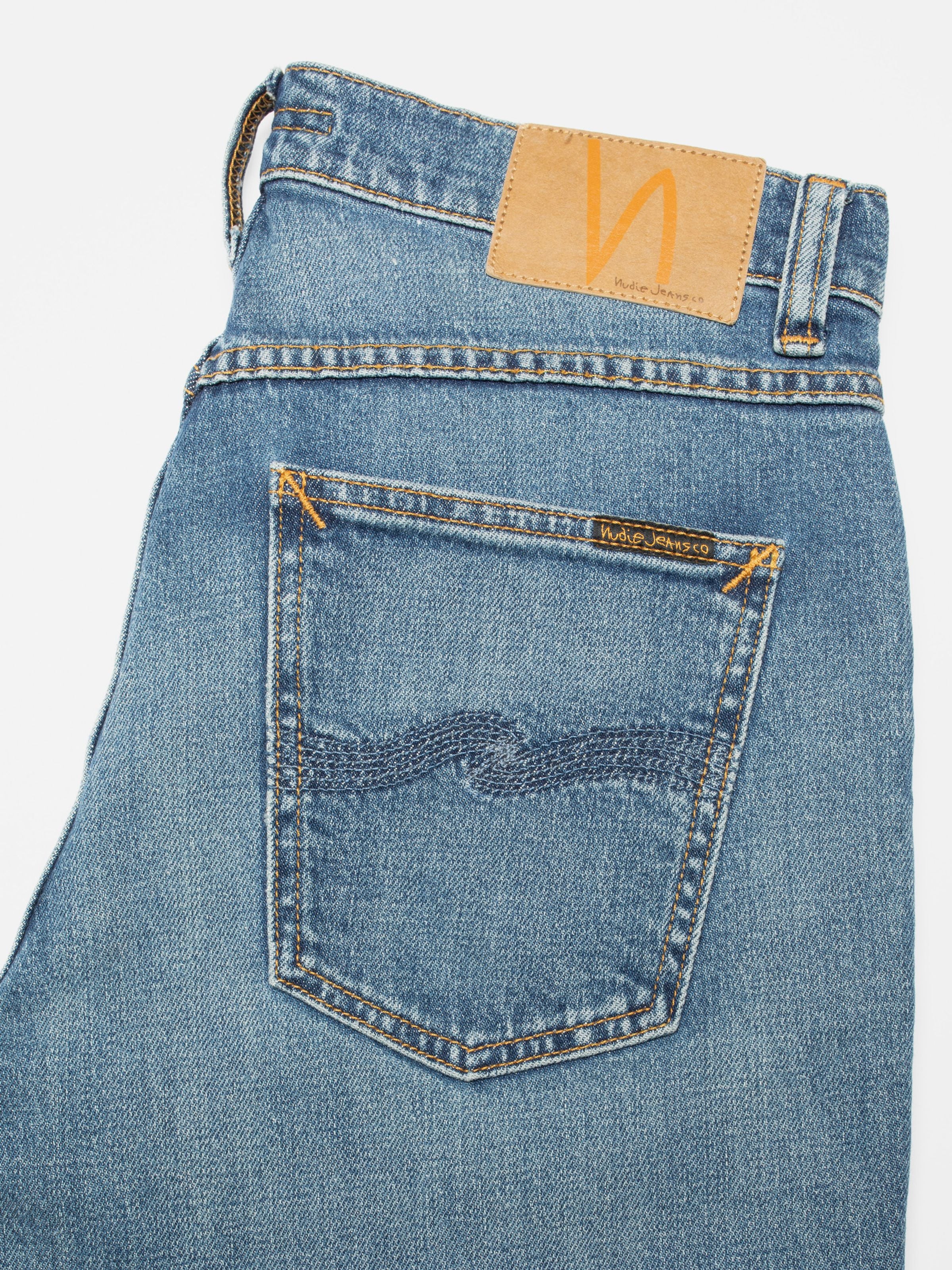 Nudie Jeans Solid Ollie Blue Blur, men's slim fit jeans, showing a close-up of the back pocket and jacron patch.