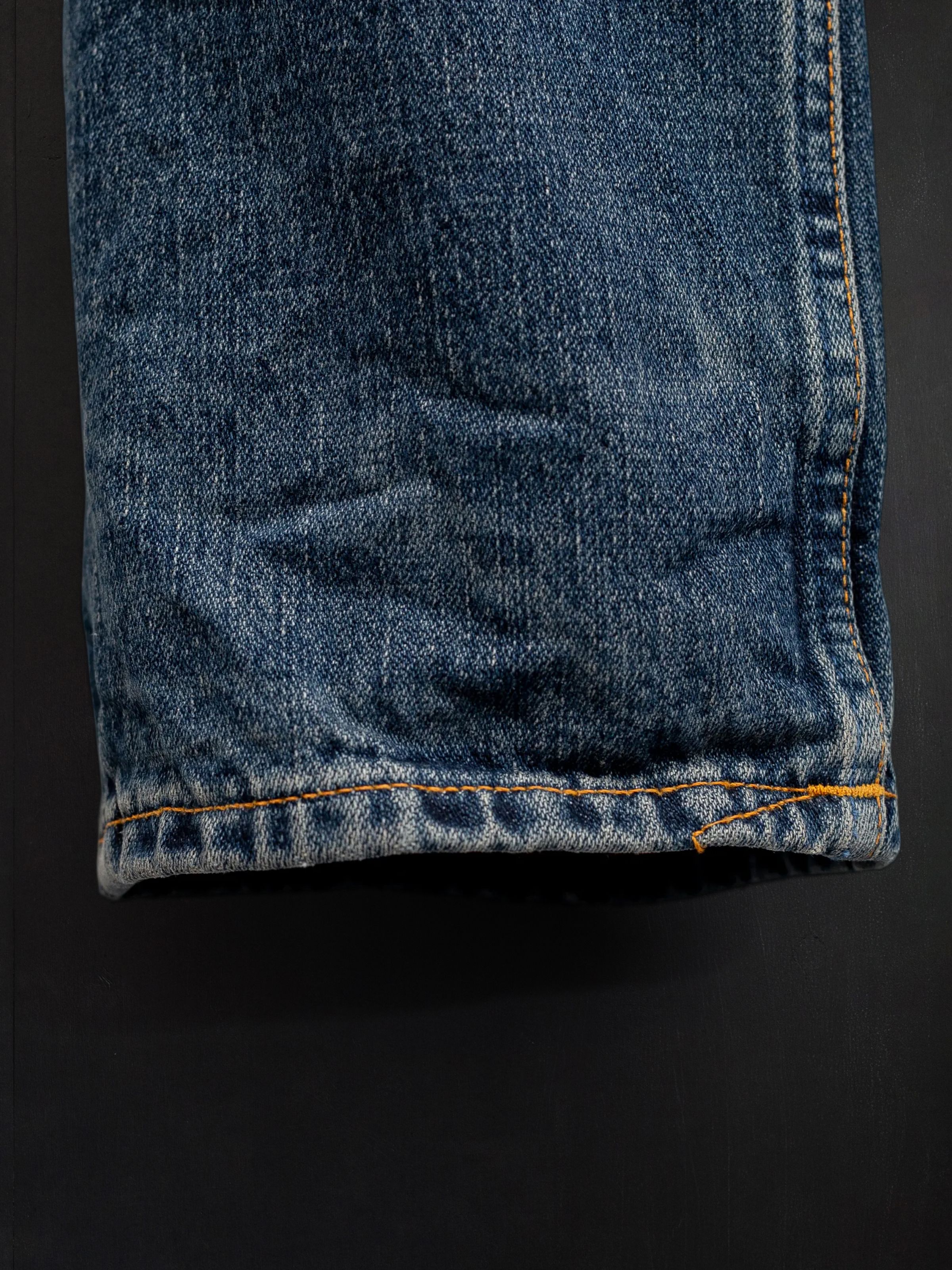 Nudie Jeans Rad Rufus Sand Tracks, men's regular fit jeans, showing a close-up of the hem.