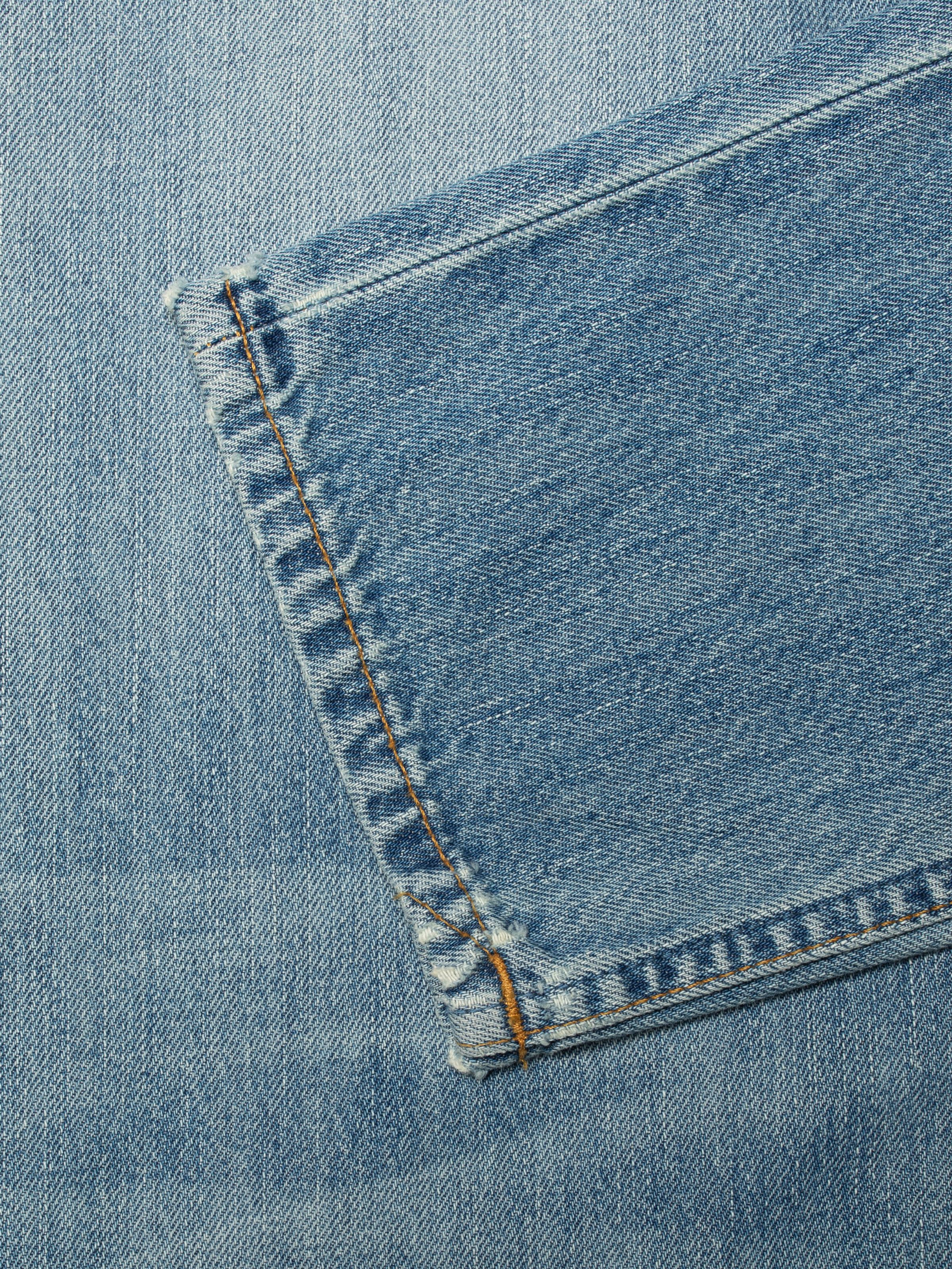 Nudie Jeans Steady Eddie II Washed Up, men's regular fit jeans, showing a close-up of the back pocket and tobacco stitching.