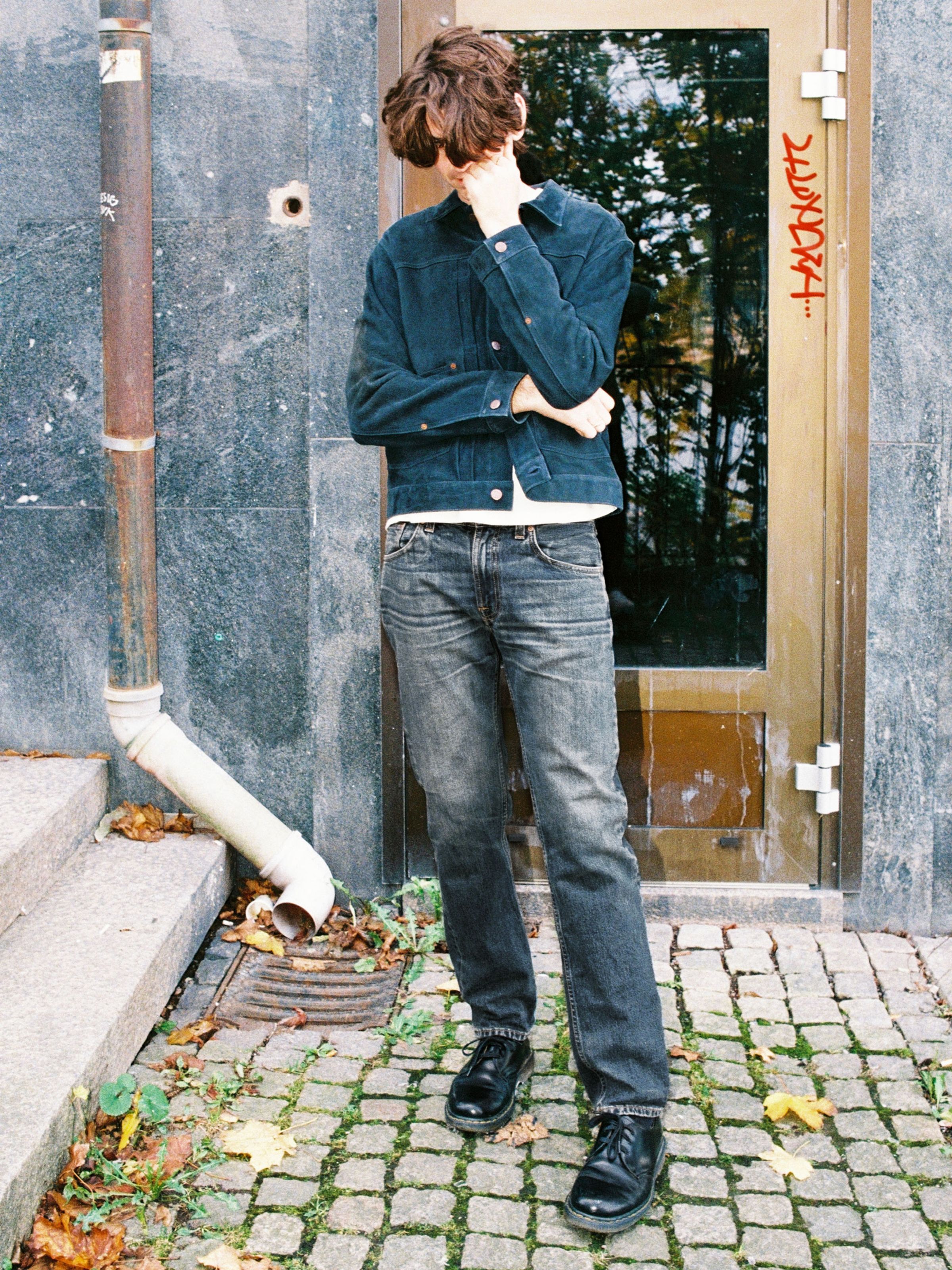 Nudie Jeans Gritty Jackson Sand Tracks, men's regular fit jeans, shown full-length on a model standing outdoors.