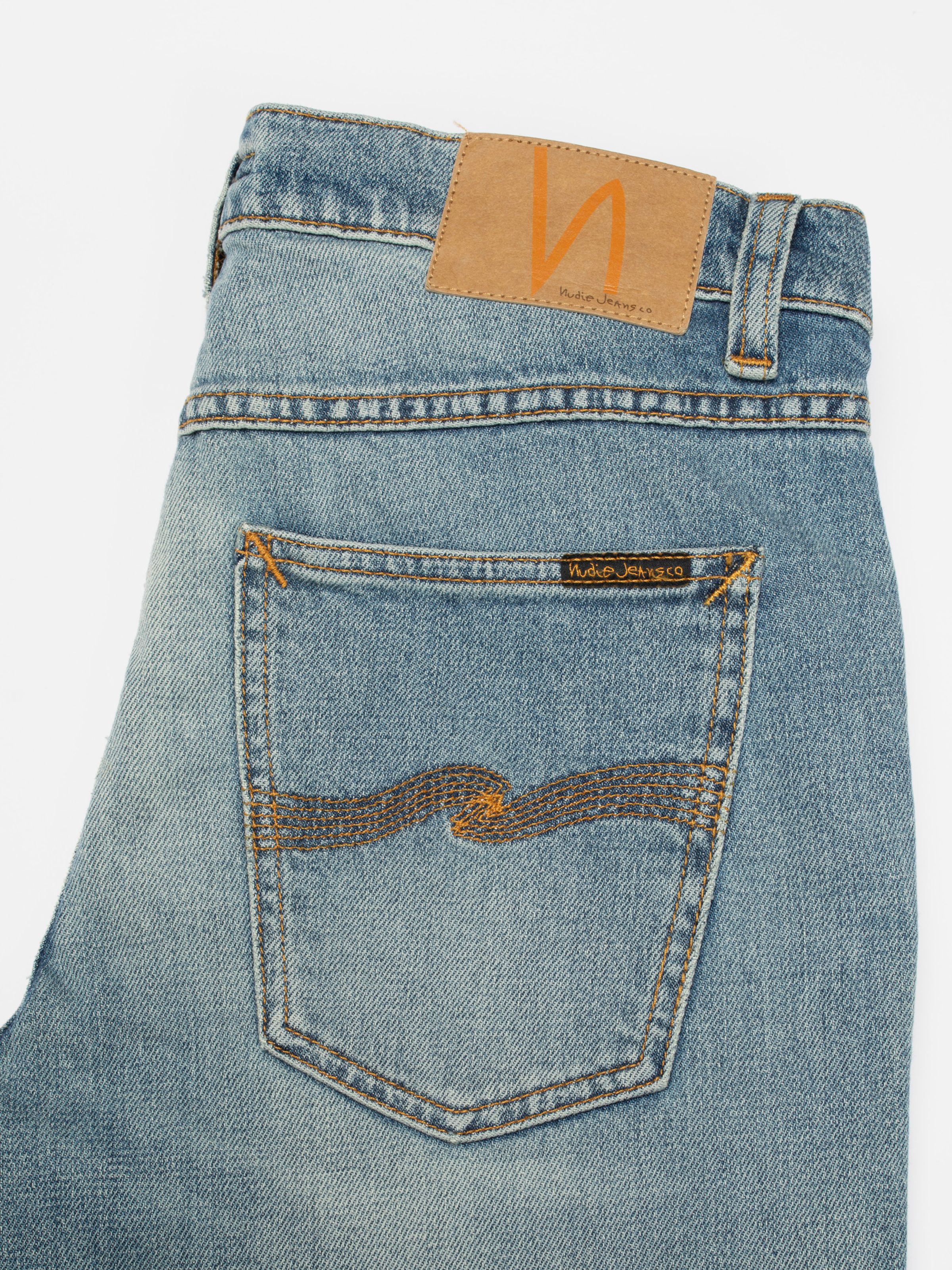 Nudie Jeans Solid Ollie Salt Water, men's slim fit jeans, showing a close-up of the back pocket and jacron patch.