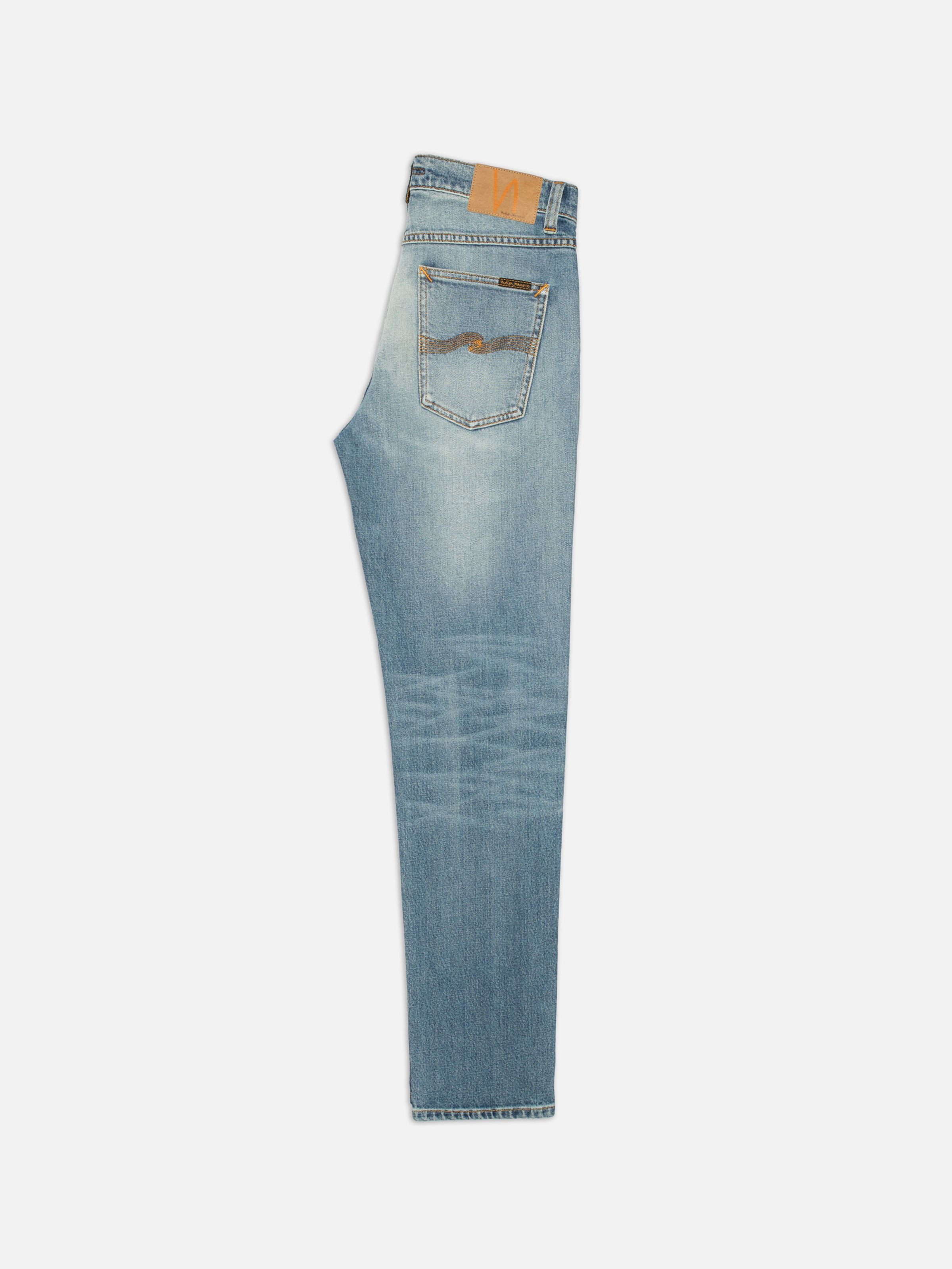Nudie Jeans Solid Ollie Salt Water, men's slim straight jeans, shown folded and laid flat to display the back pocket detail.