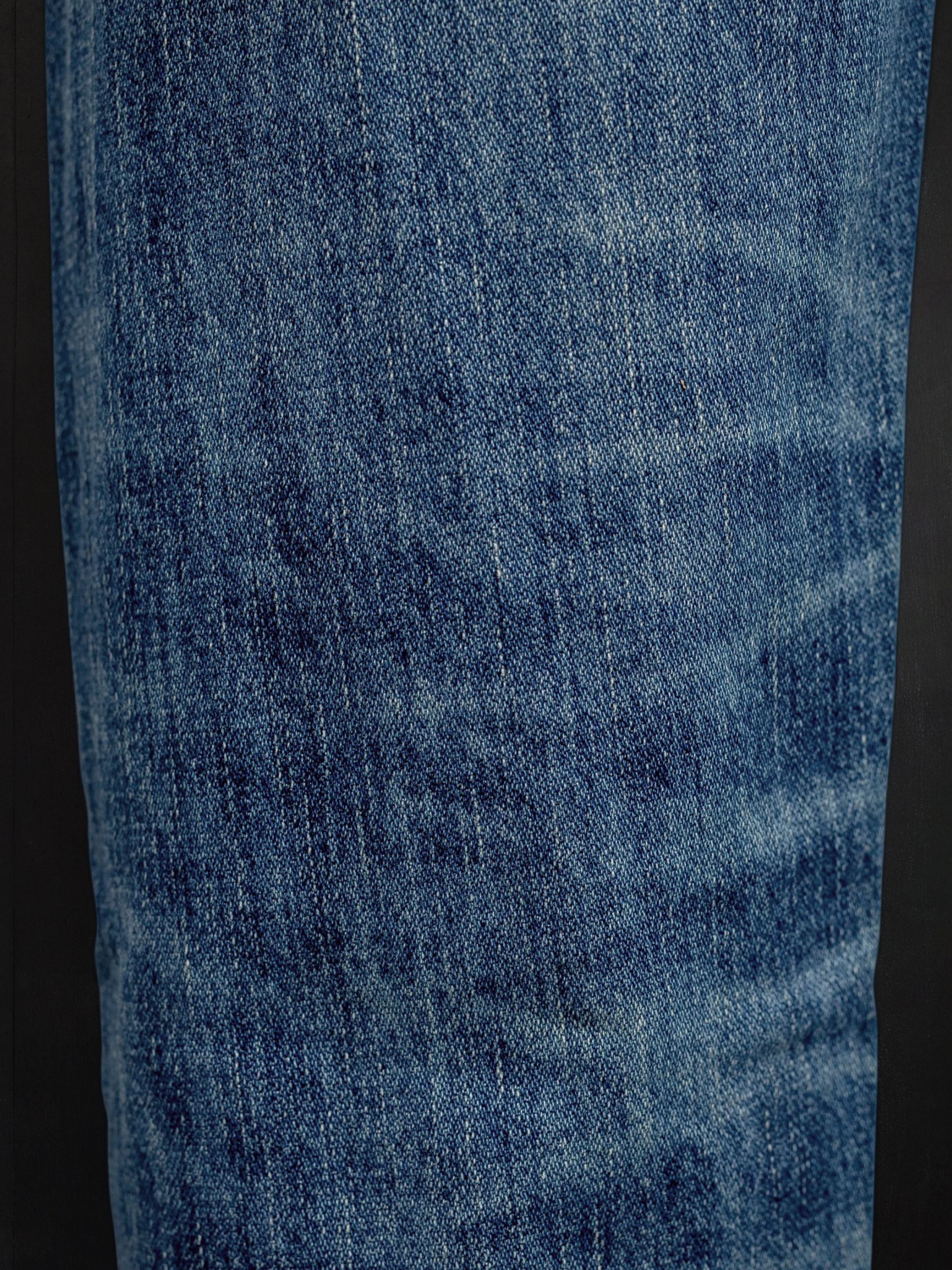 Nudie Jeans Steady Eddie II Muted Tracks, men's regular tapered jeans, showing a close-up of the washed denim fabric.