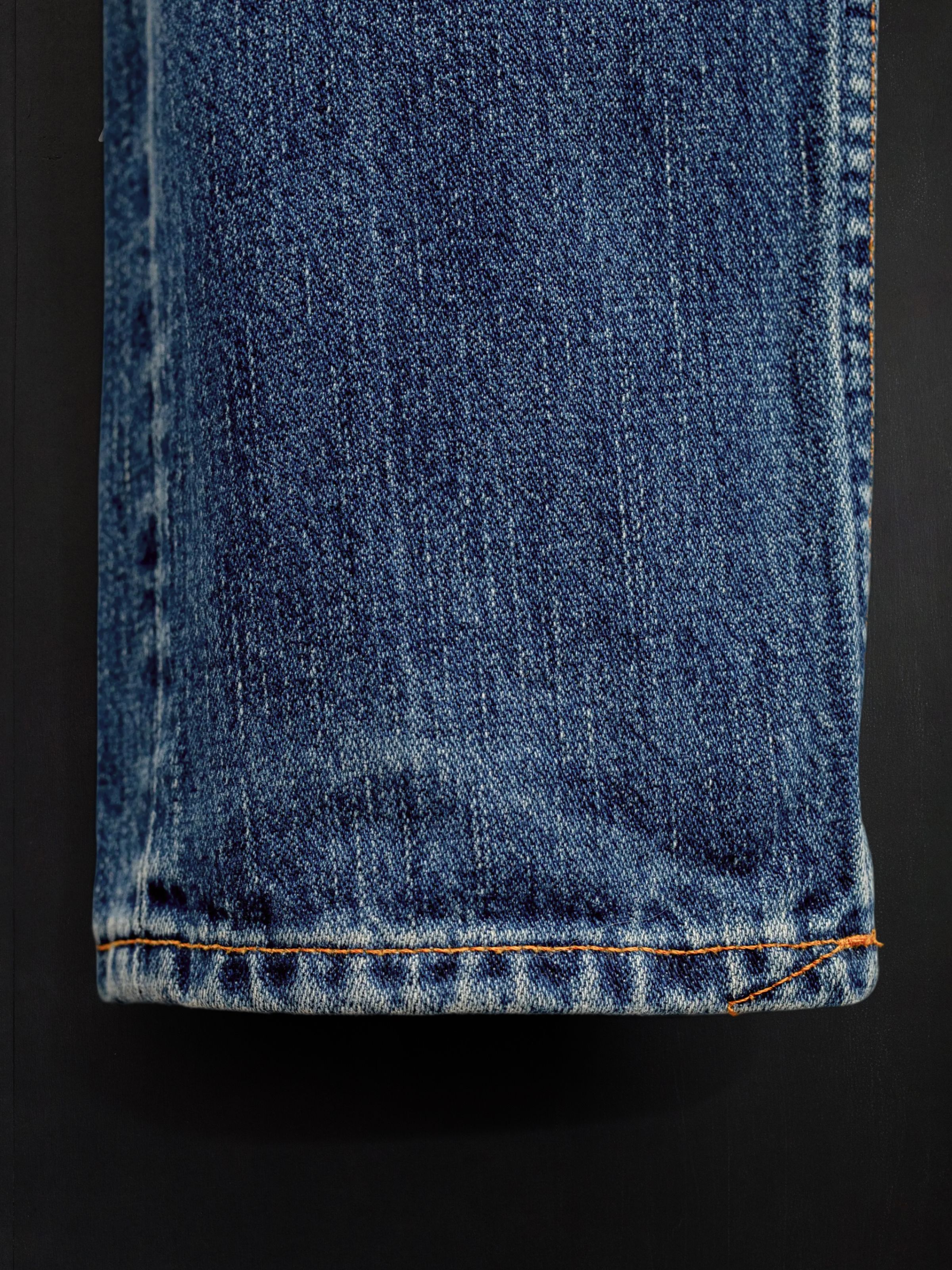 Nudie Jeans Steady Eddie II Muted Tracks, men's regular tapered jeans, showing a close-up of the hem.