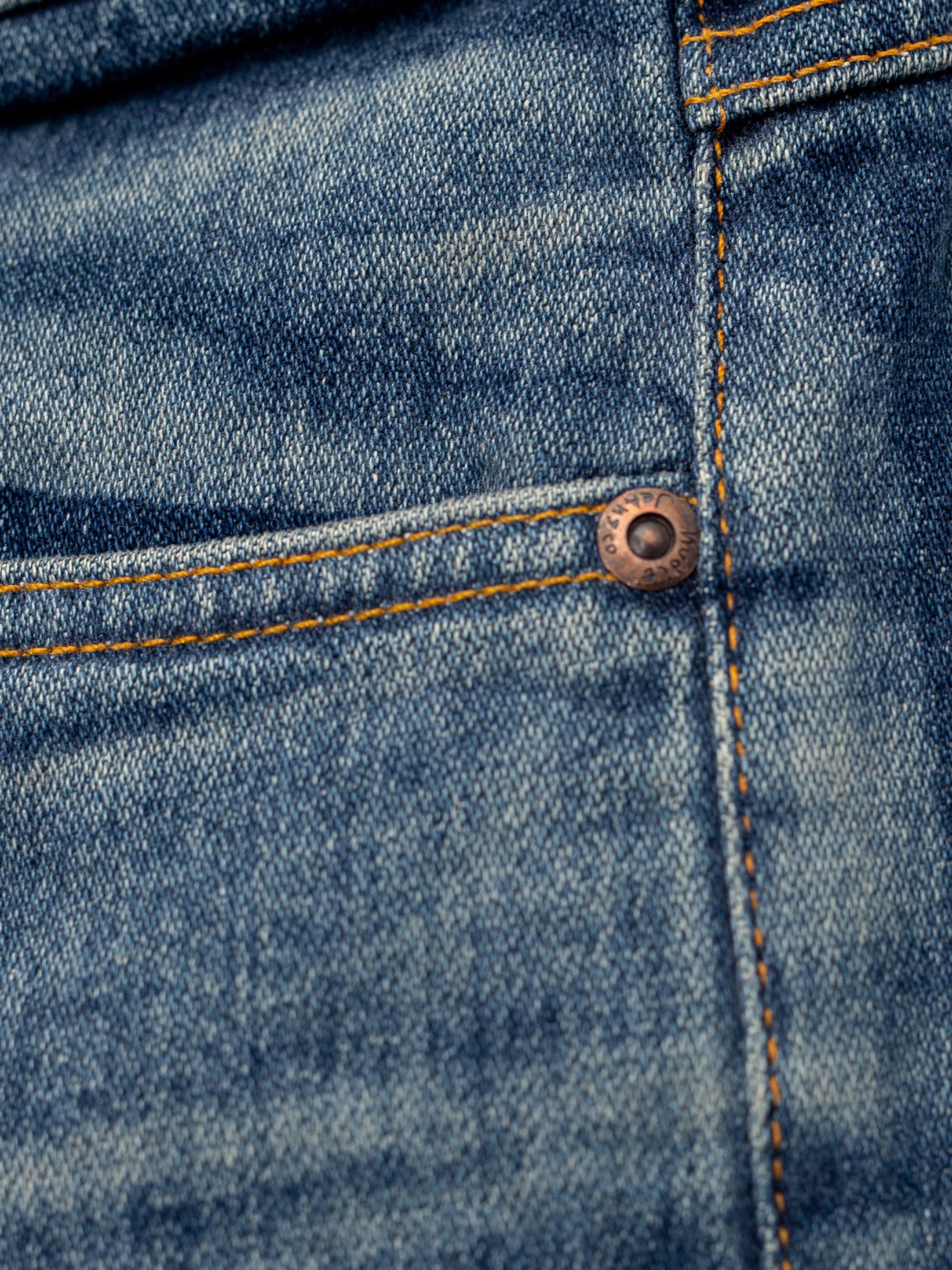 Nudie Jeans Lean Dean Salty Tracks, men's slim tapered jeans, showing a close-up of the front coin pocket and copper rivet.