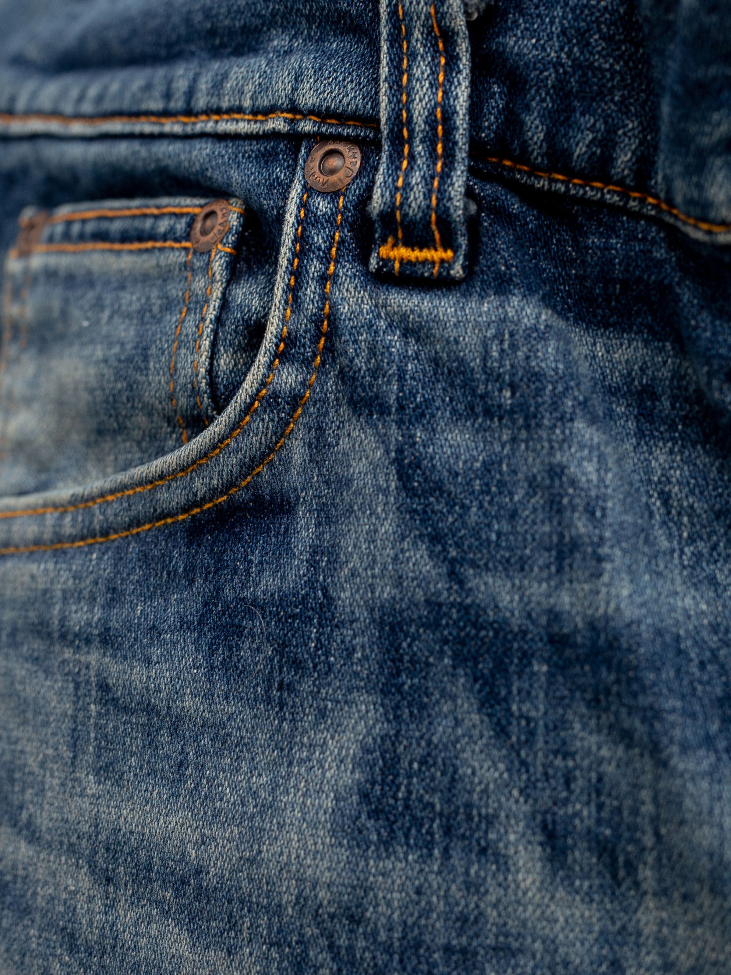 Nudie Jeans Lean Dean Salty Tracks, men's slim tapered jeans, showing a close-up of the front pocket.