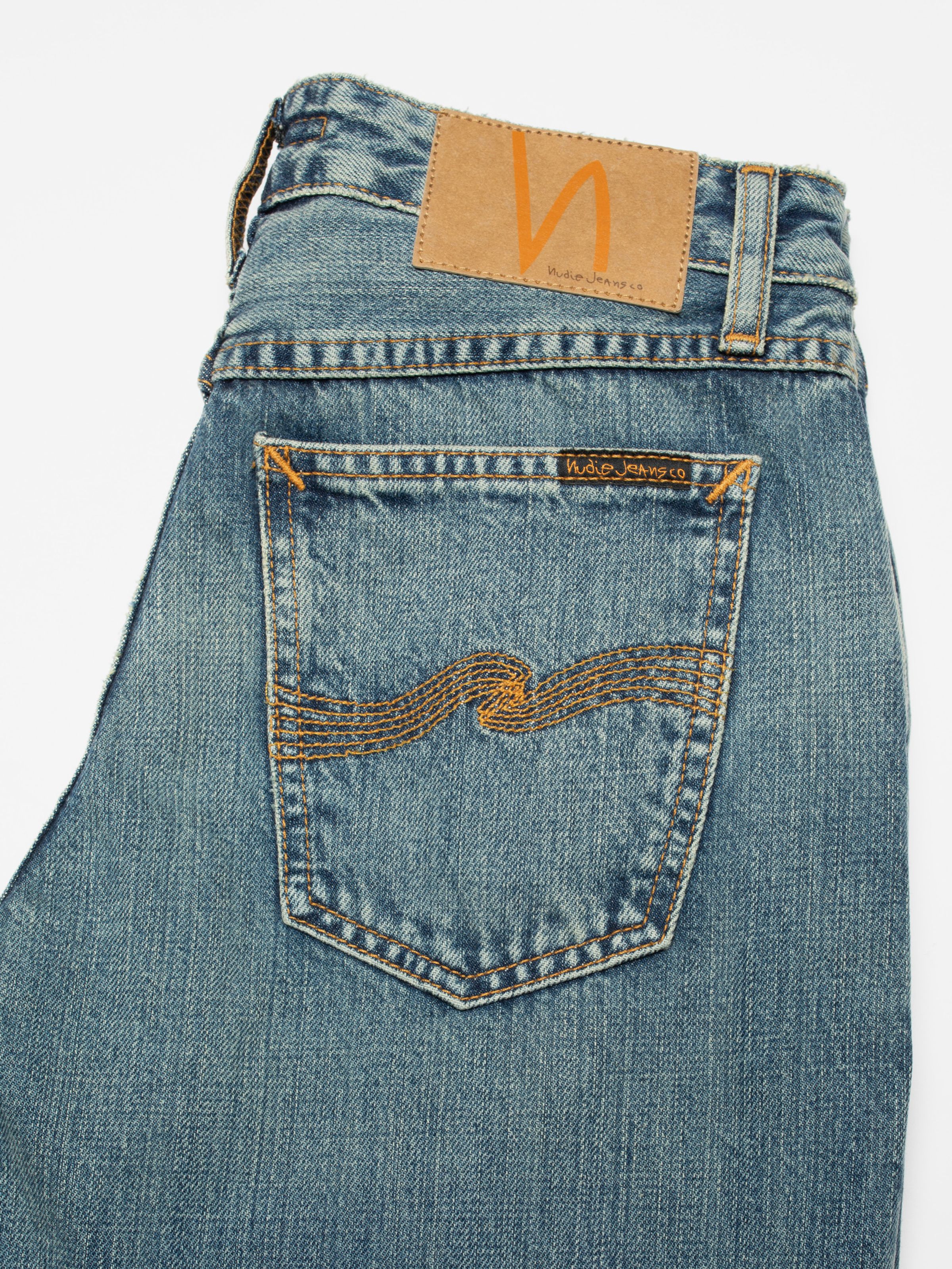 Nudie Jeans Dusty Dee Streaky Wash, women's flared jeans, shown in a close-up of the back pocket and jacron patch.
