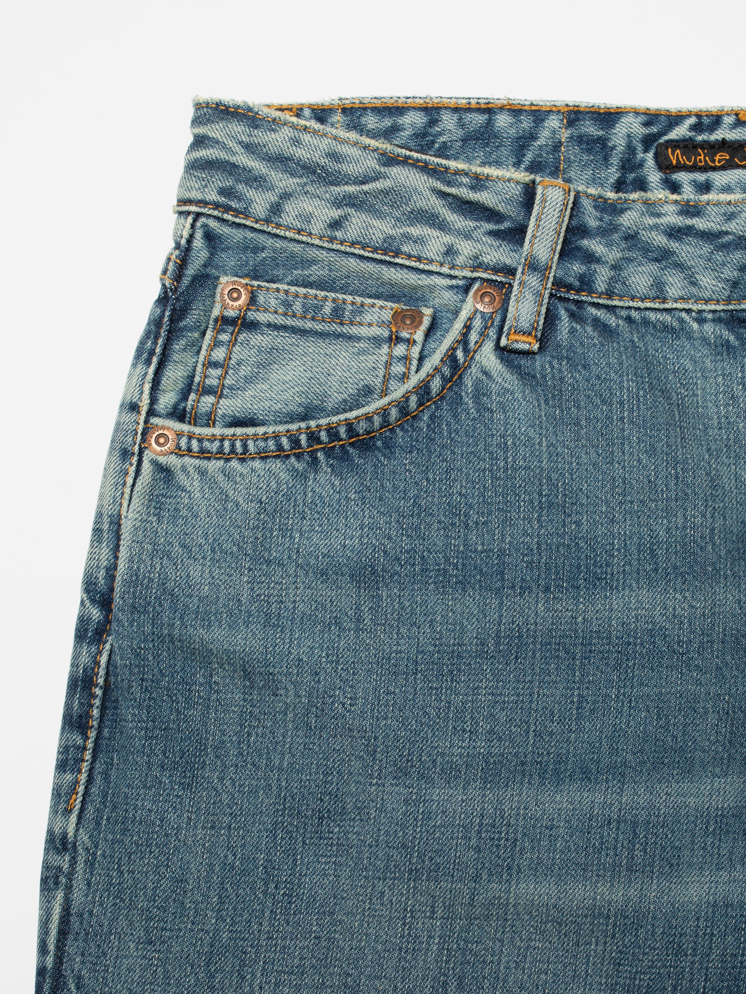 Nudie Jeans Dusty Dee Streaky Wash, women's flared jeans, close-up of the front pocket and waistband.