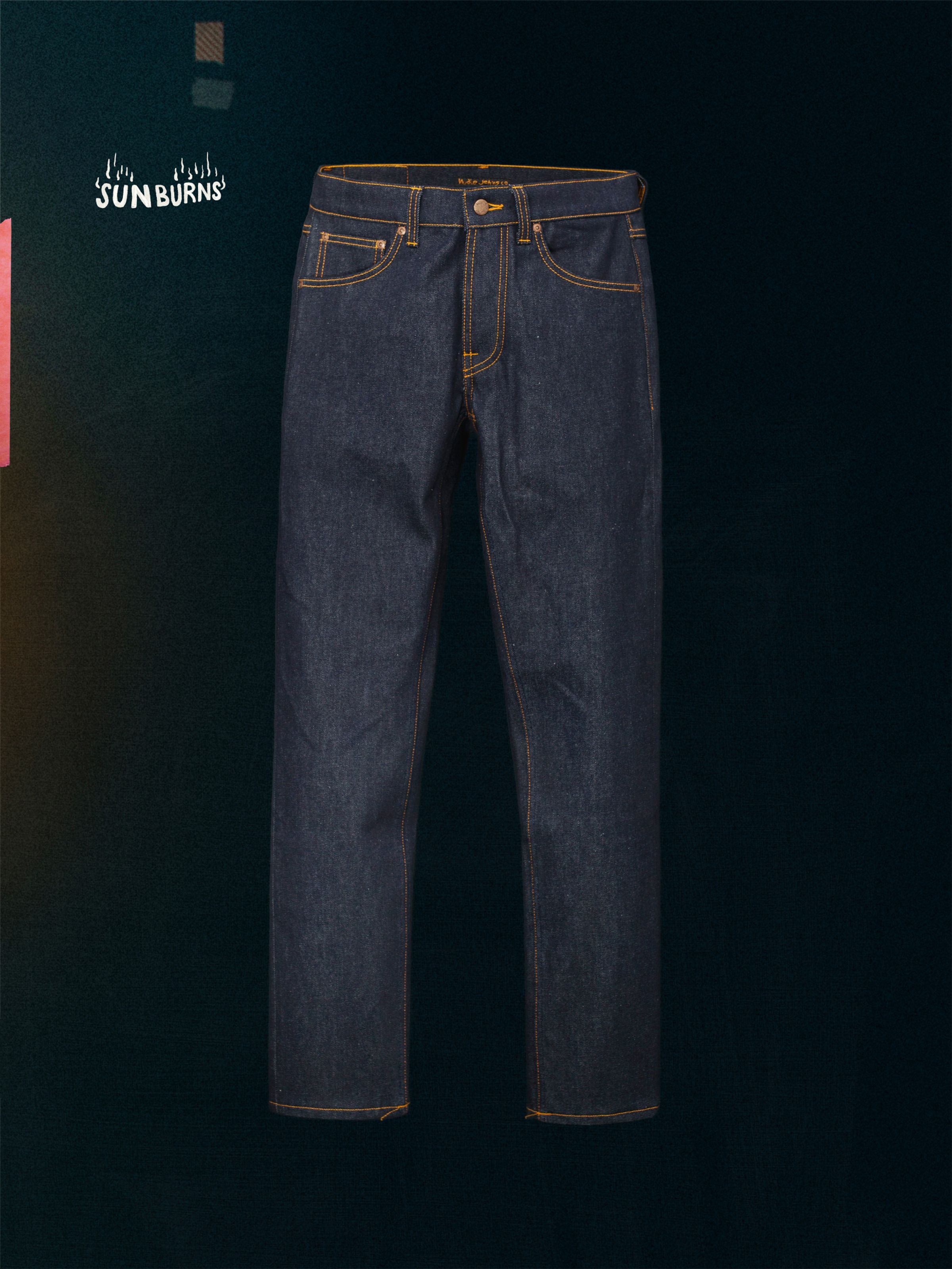 Nudie Jeans Solid Ollie Dry Sunburns, a pair of men's slim straight fit jeans in dry blue denim, shown laid flat.