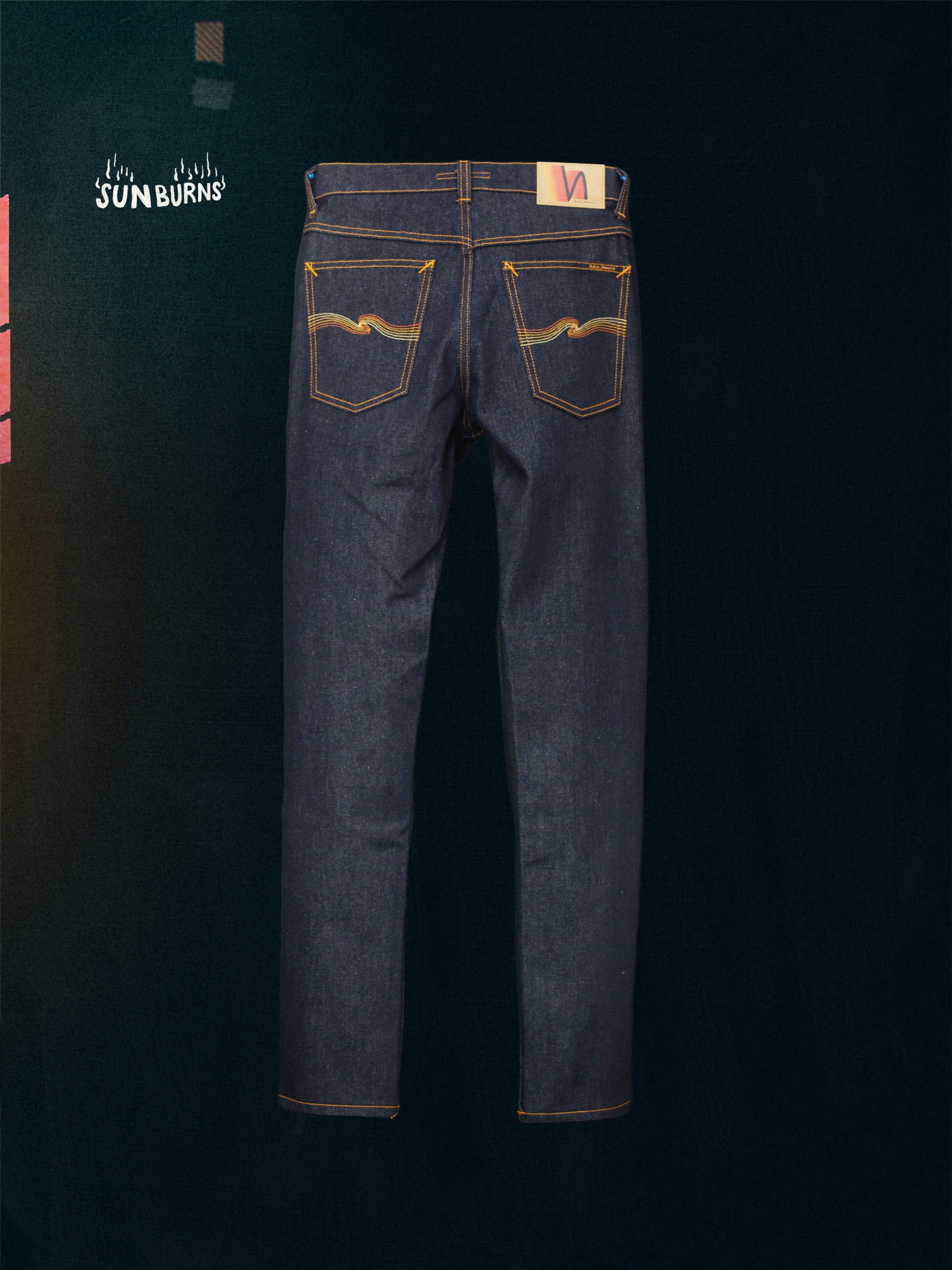 Nudie Jeans Solid Ollie Dry Sunburns, a pair of men's slim fit jeans in dry blue denim, shown laid flat from the back.