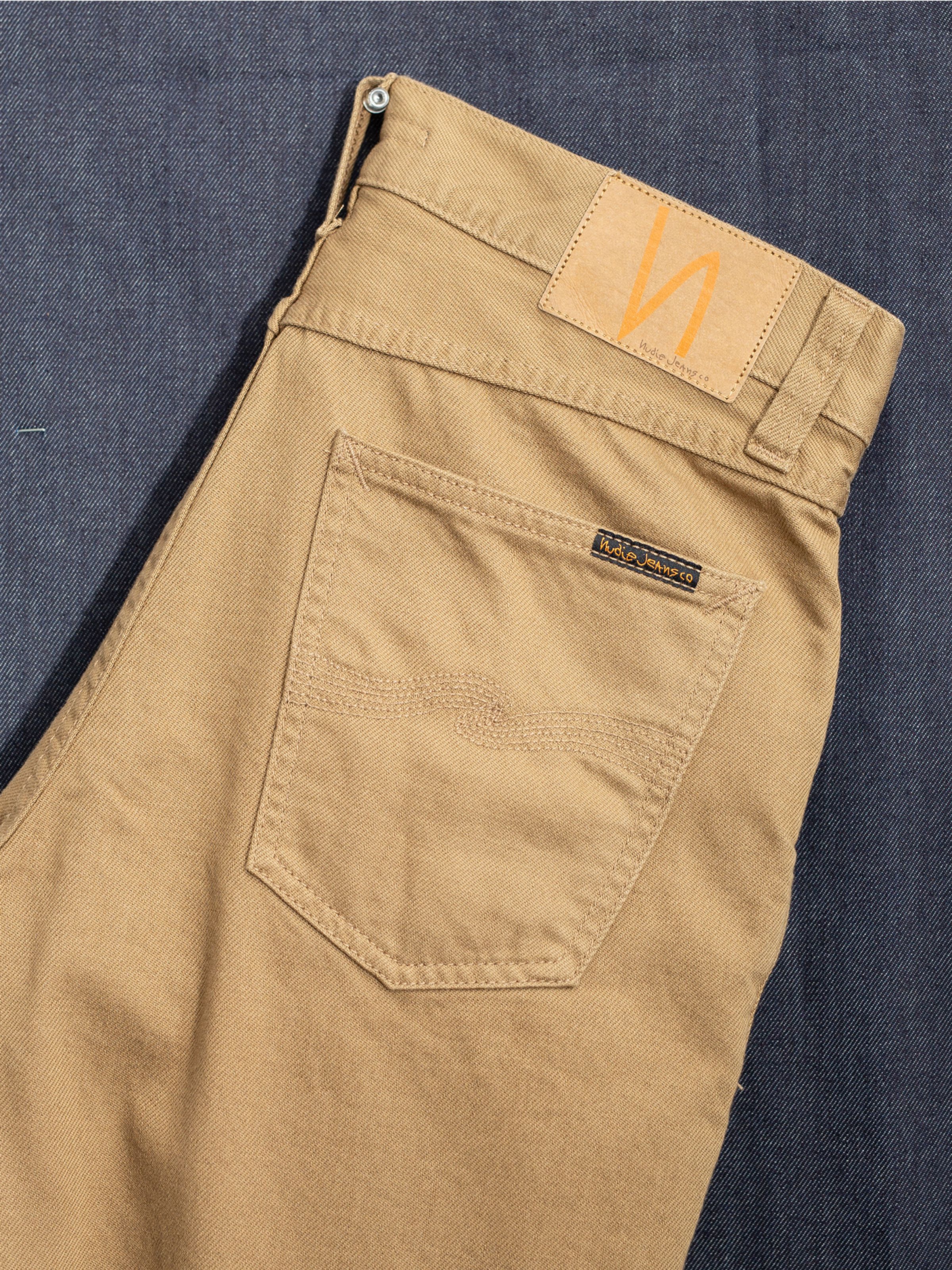Nudie Jeans Rad Rufus Everlion, men's jeans, showing a close-up of the back pocket and jacron patch.