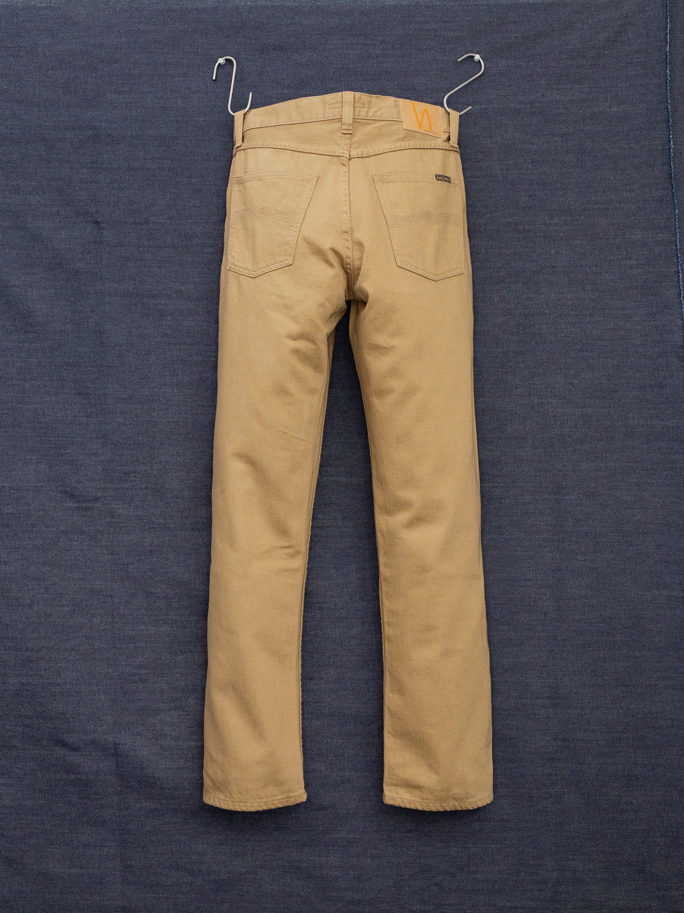 Nudie Jeans Rad Rufus Everlion, men's regular fit straight leg jeans in beige, shown from the back hanging.