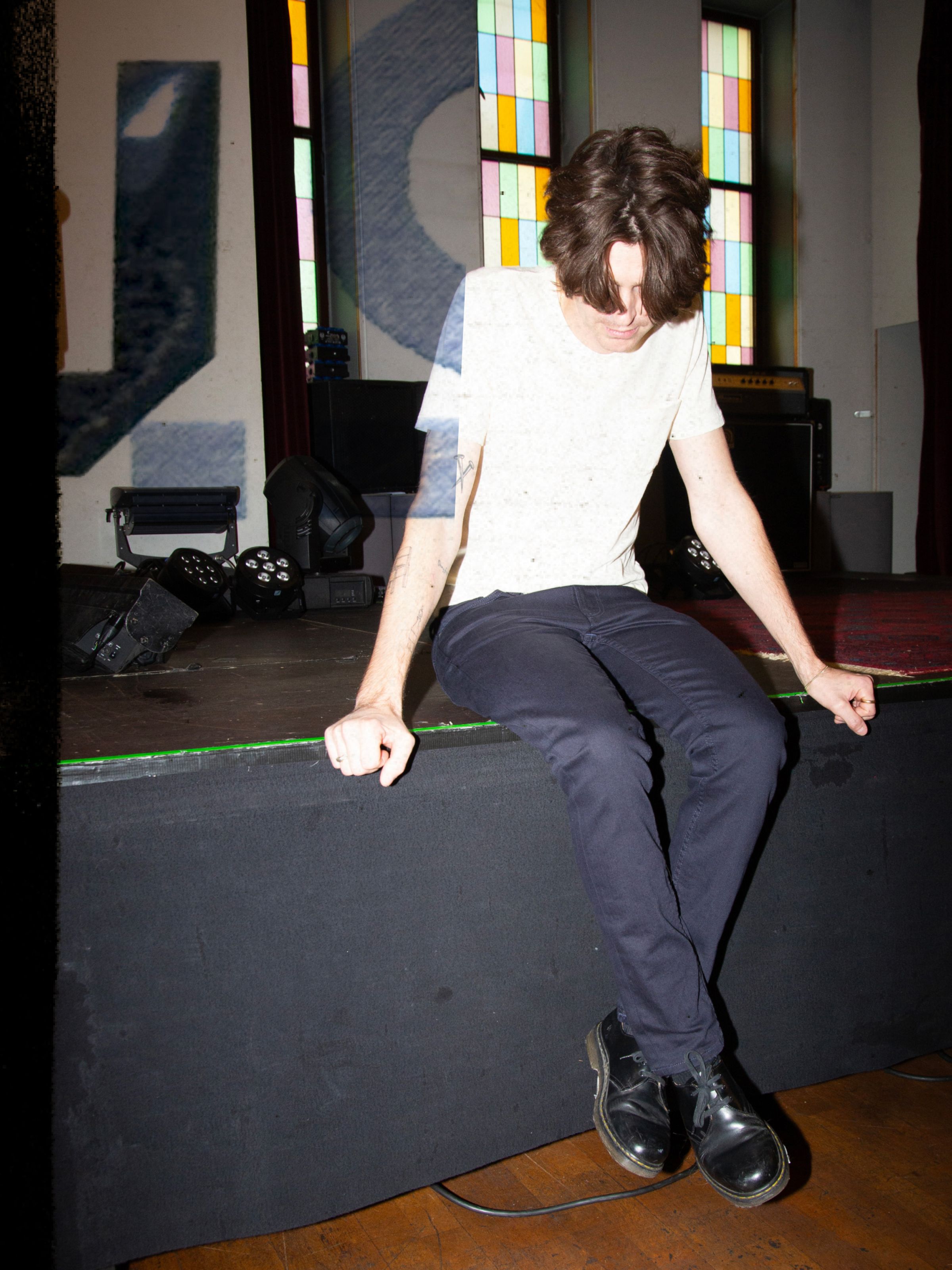 Nudie Jeans Lean Dean Everblue, men's slim tapered jeans shown on a model sitting on a stage.