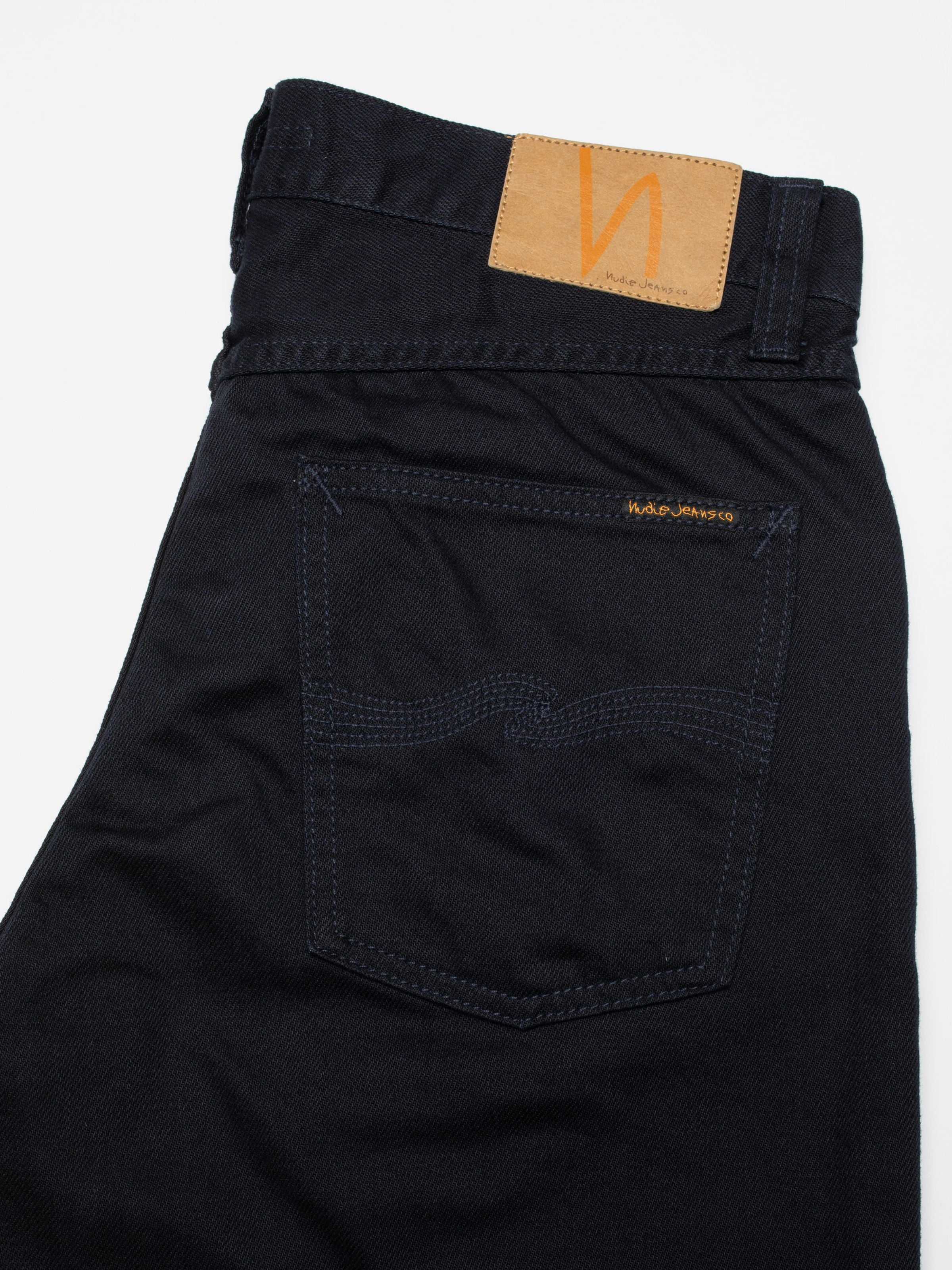 Nudie Jeans Rad Rufus Everblue, men's regular fit jeans, showing a close-up of the back pocket and jacron patch.