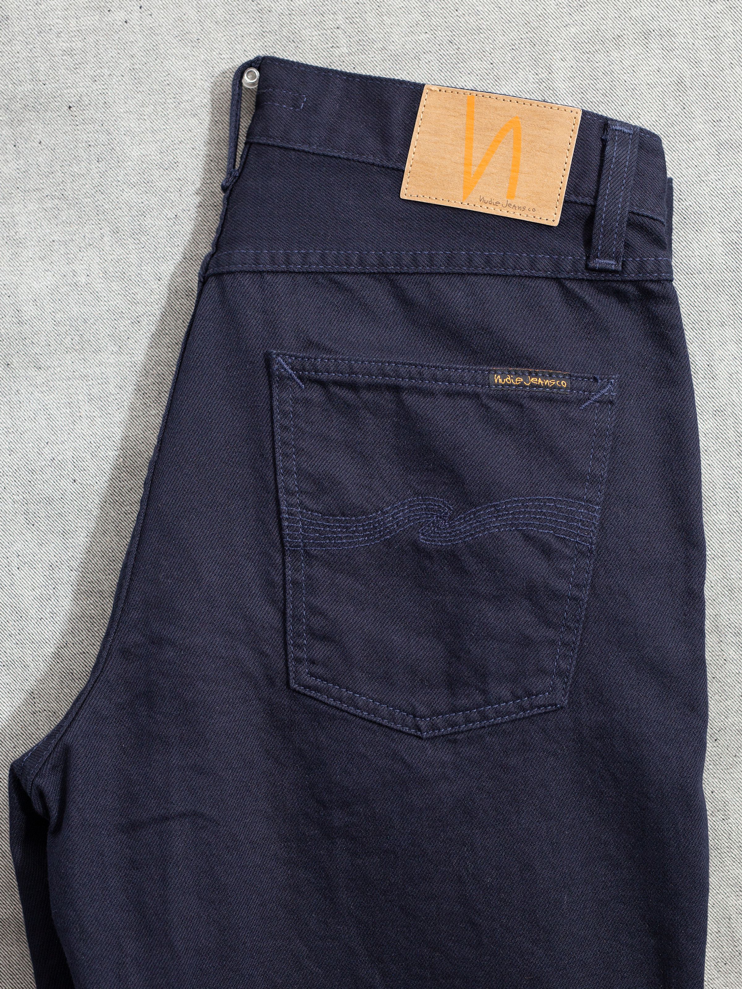Nudie Jeans Rad Rufus Everblue, men's regular fit jeans, showing a close-up of the back pocket and jacron patch.