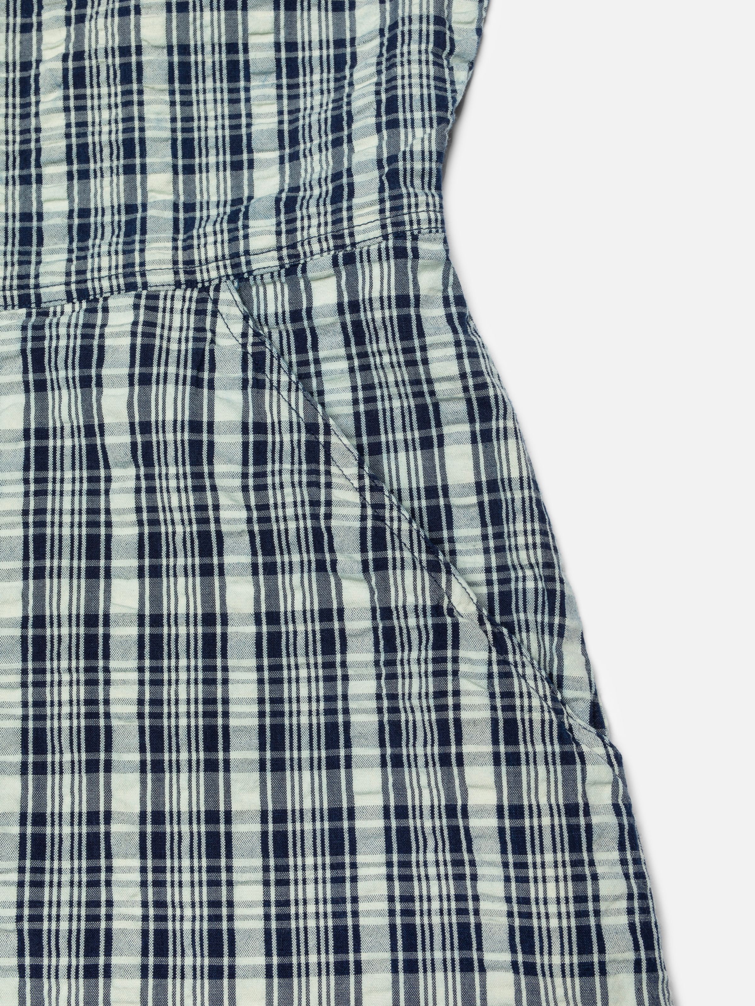 Nudie Jeans Ronja Dress Indigo Seersucker, close-up of the side pocket and checked fabric texture.