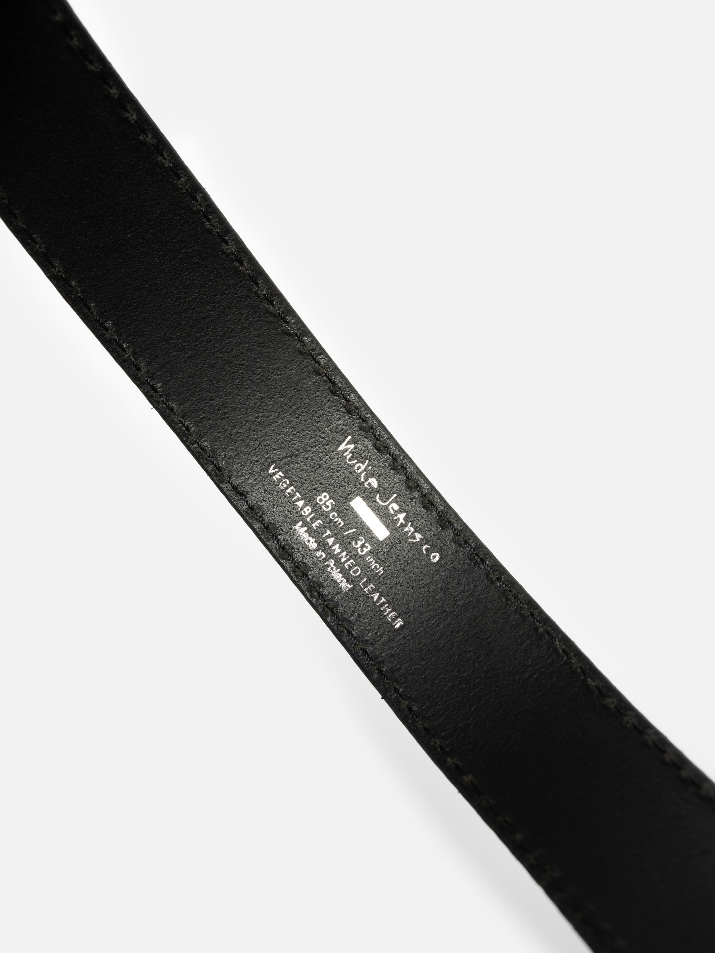Nudie Jeans Faux Reptile Leather Belt in Black, close-up of the silver branding and size stamp on the interior.