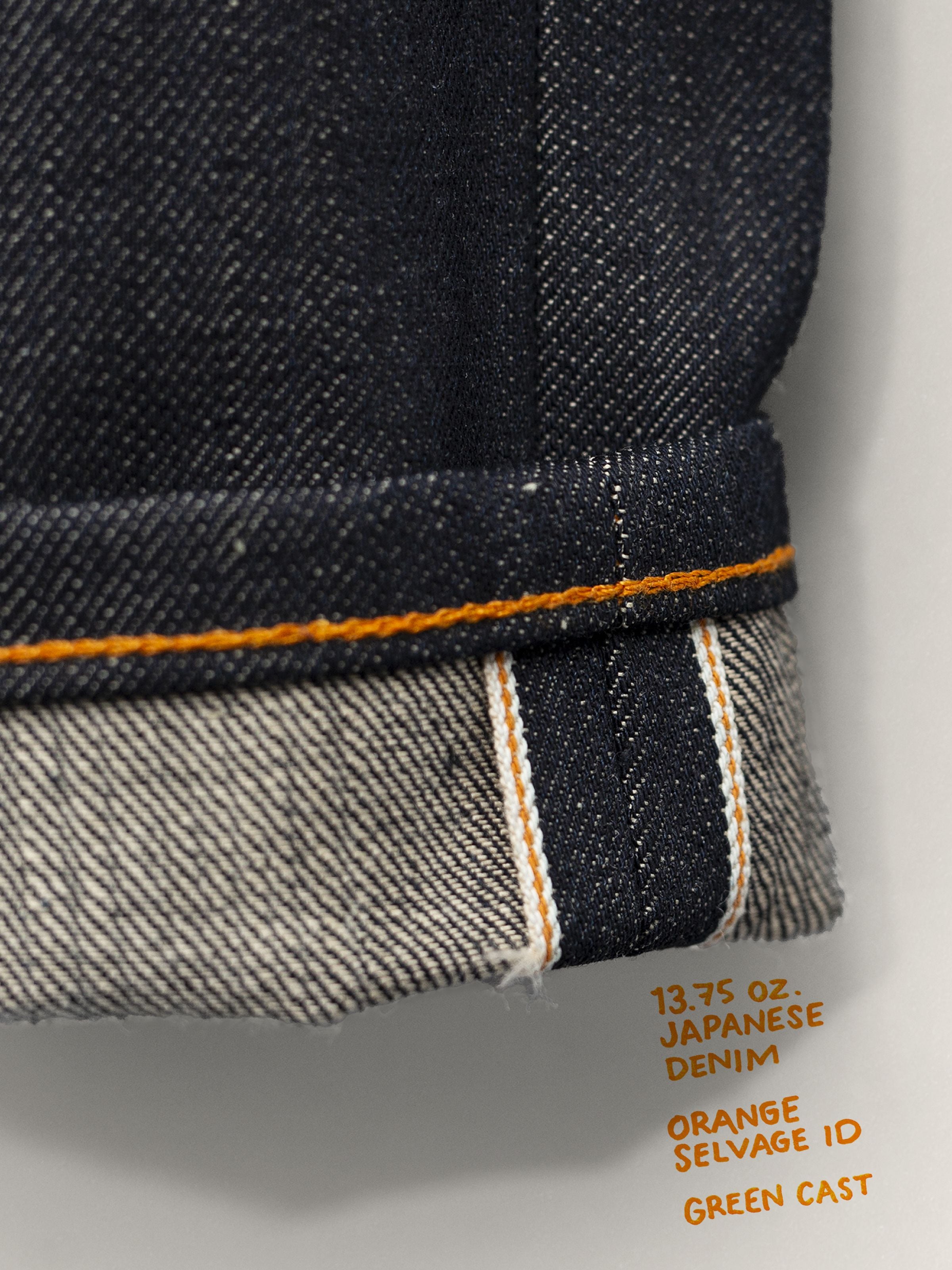 Nudie Jeans Regular Alf Dry Selvage, close-up of the cuffed hem showing the rigid selvedge denim texture and orange ID line.