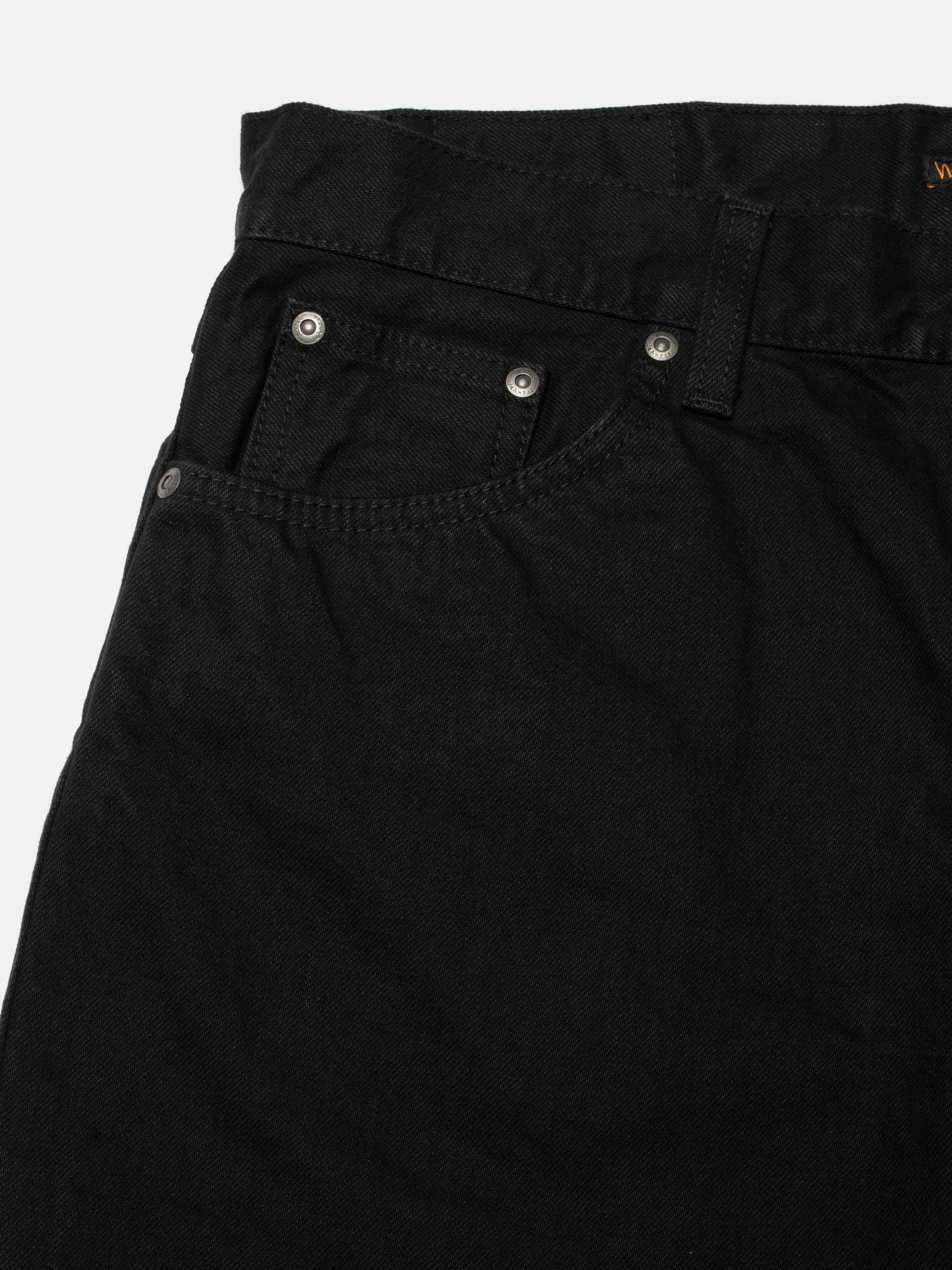 Nudie Jeans Loud Larry Black Water, a pair of men's loose fit jeans in black denim, shown in a front pocket detail shot.