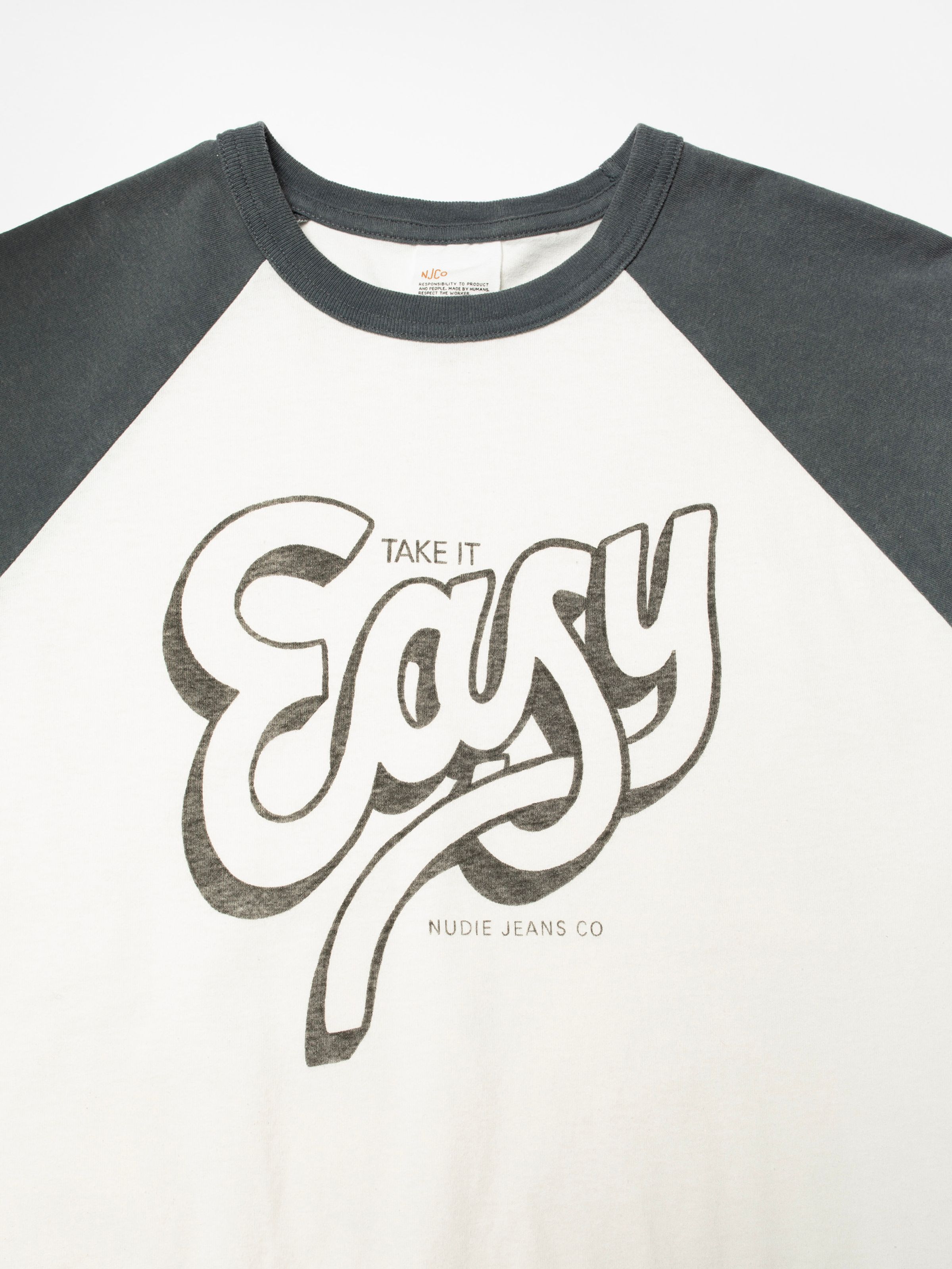 Nudie Jeans Roy Raglan T-Shirt Take It Easy, close-up of the chest print on off-white organic cotton.