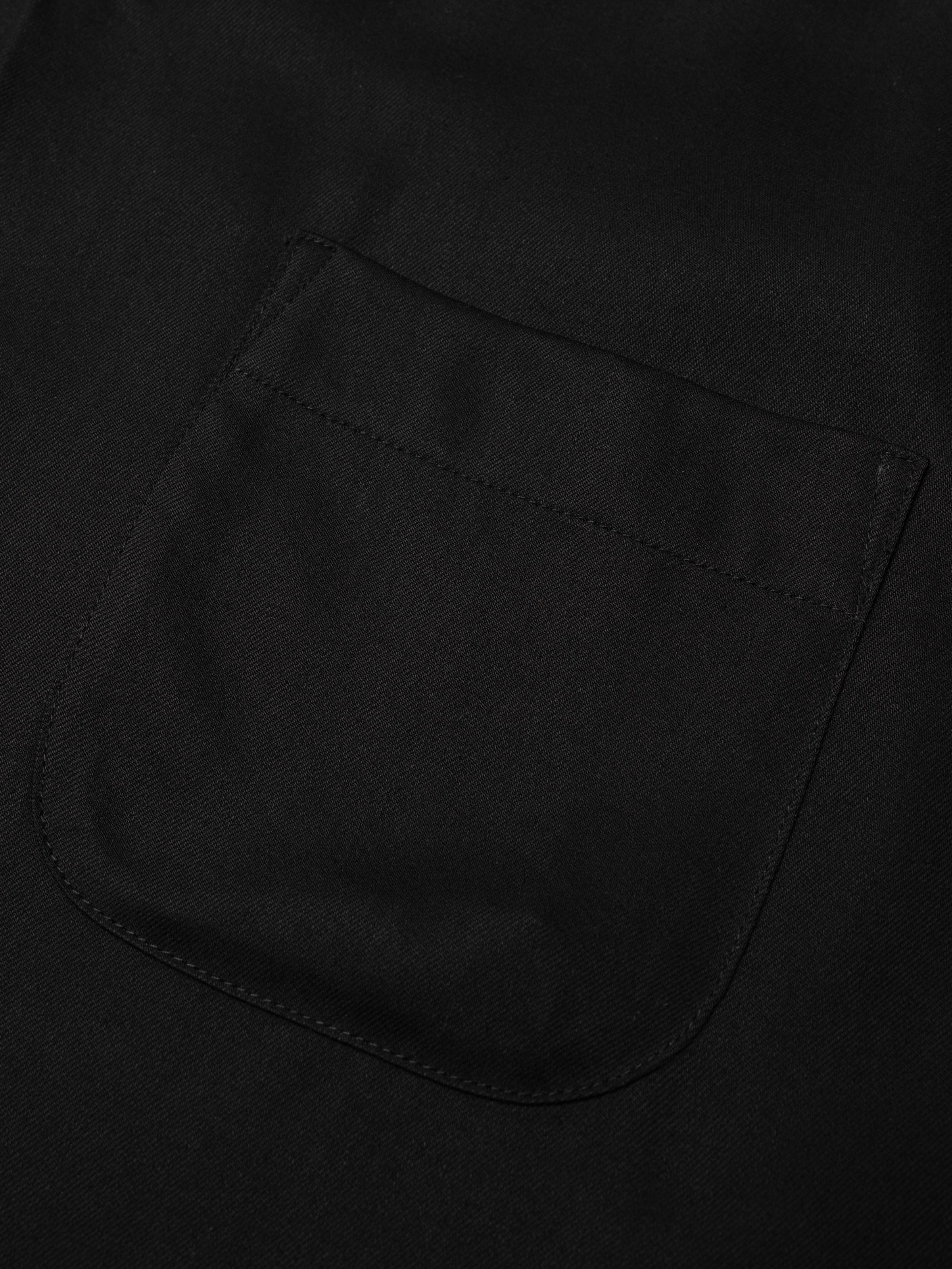 Nudie Jeans Arthur Bowling Shirt Saftey Pin in Black, close-up of the chest pocket.