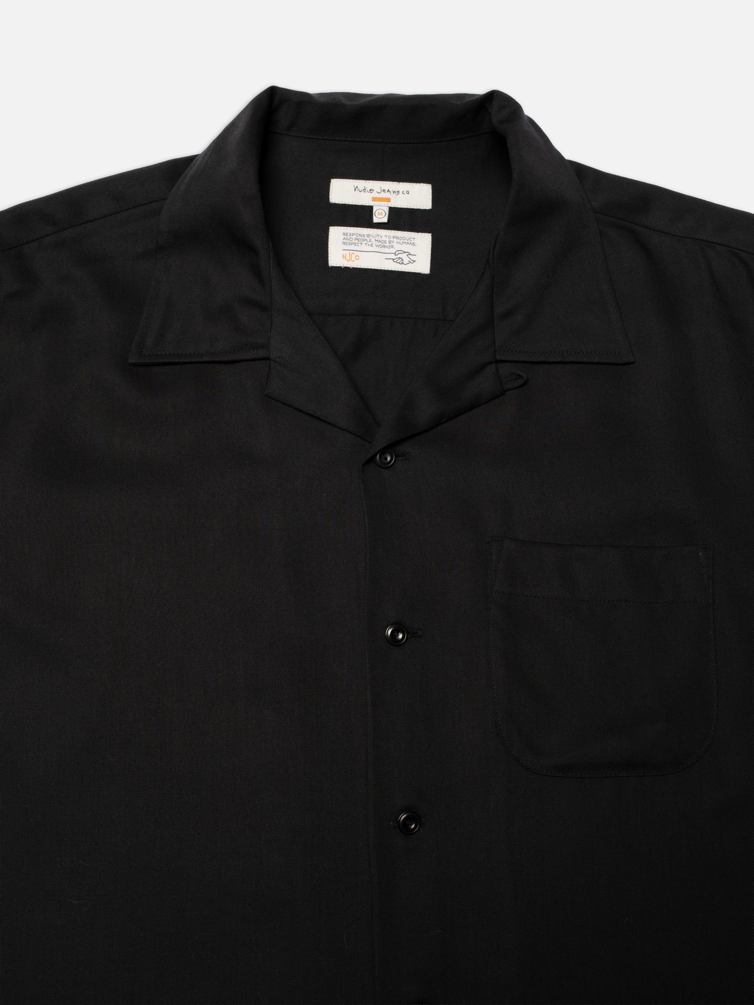Nudie Jeans Arthur Bowling Shirt Saftey Pin in Black, close-up of the camp collar and corozo buttons.