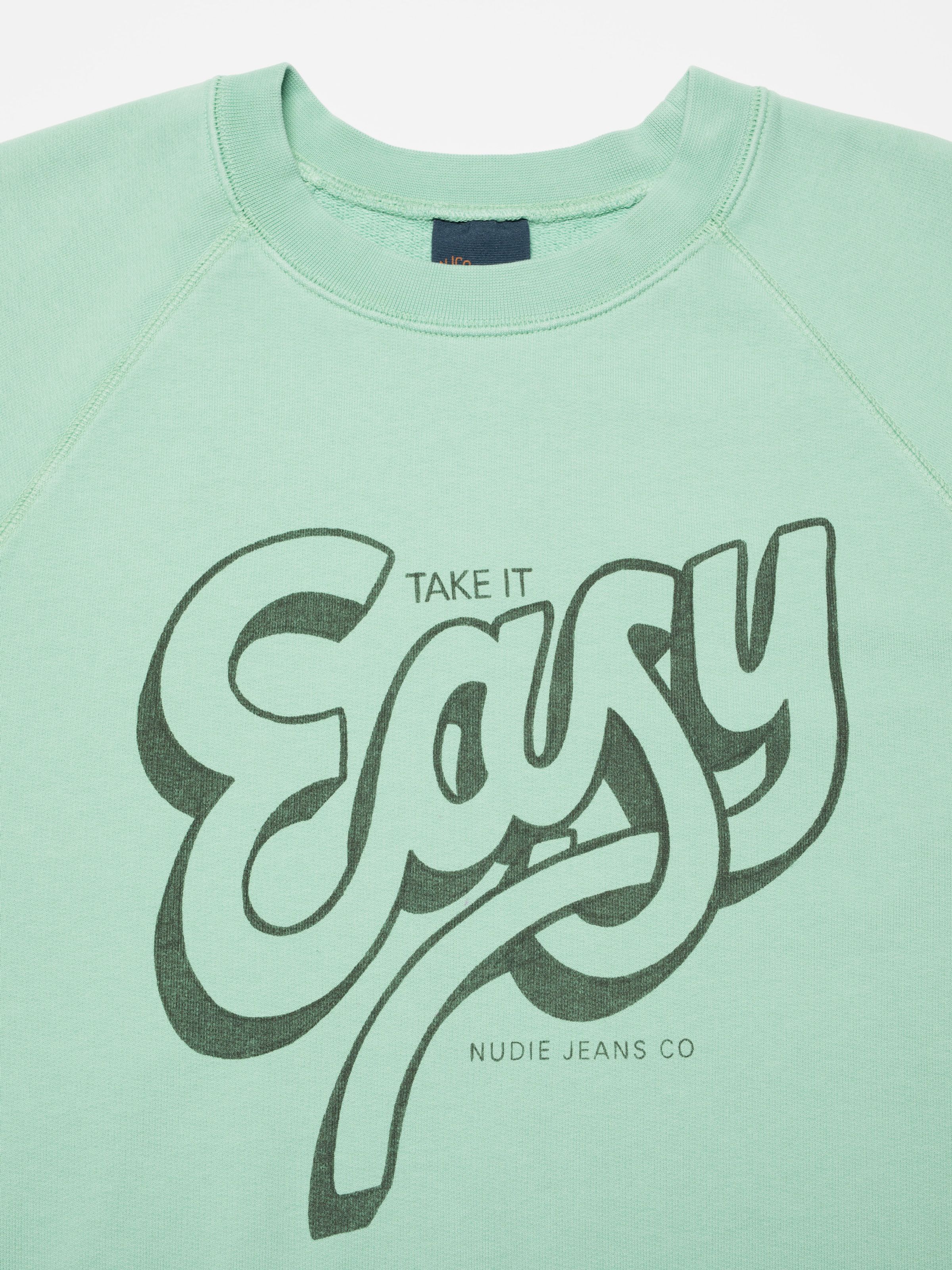Nudie Jeans Palle Sweatshirt Take It Easy in Turquoise, close-up of the chest print.