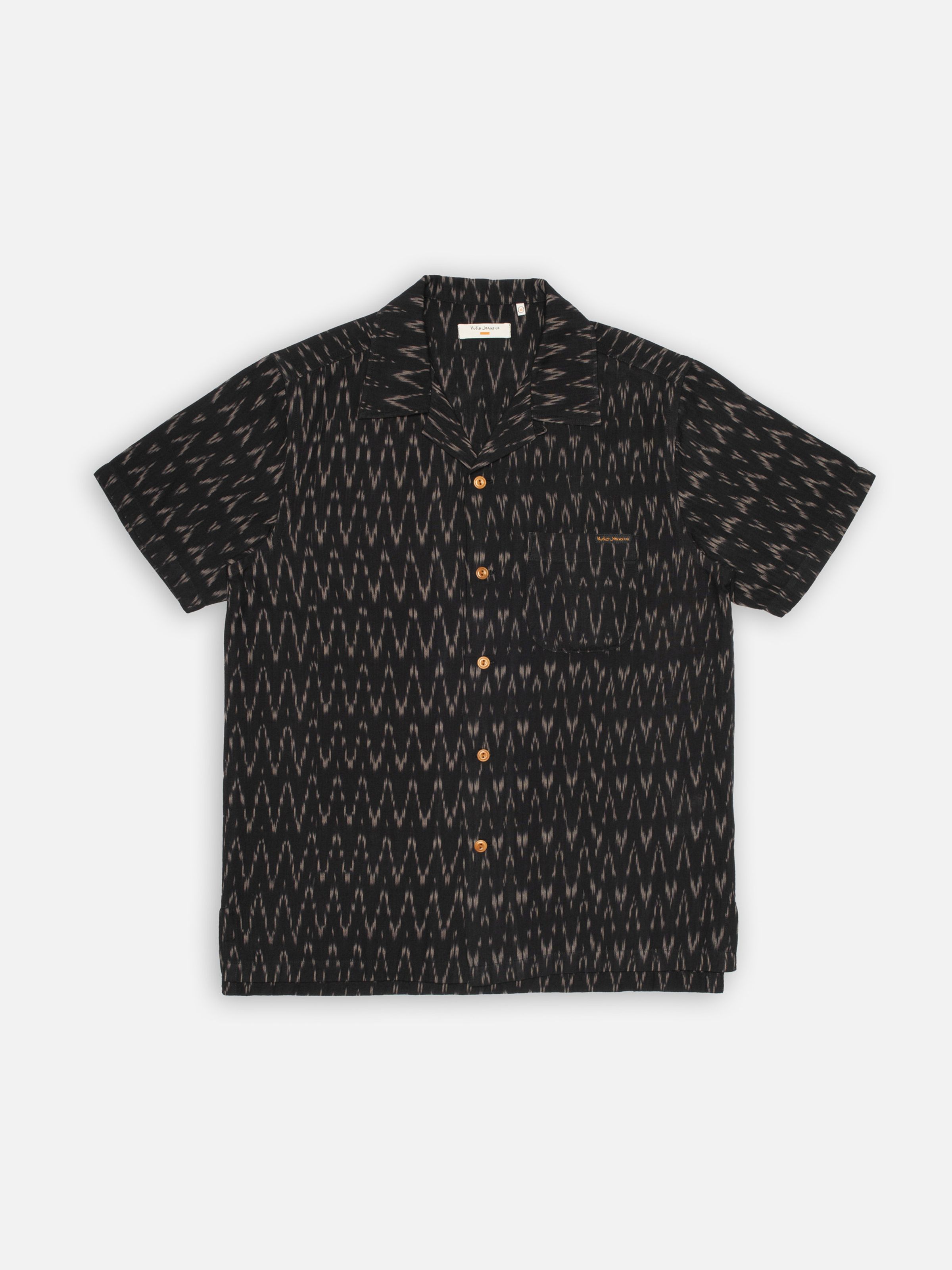 Nudie Jeans Arvid Hawaii Shirt Ikat, men's short-sleeve shirt with black ikat pattern, shown as a full flatshot.