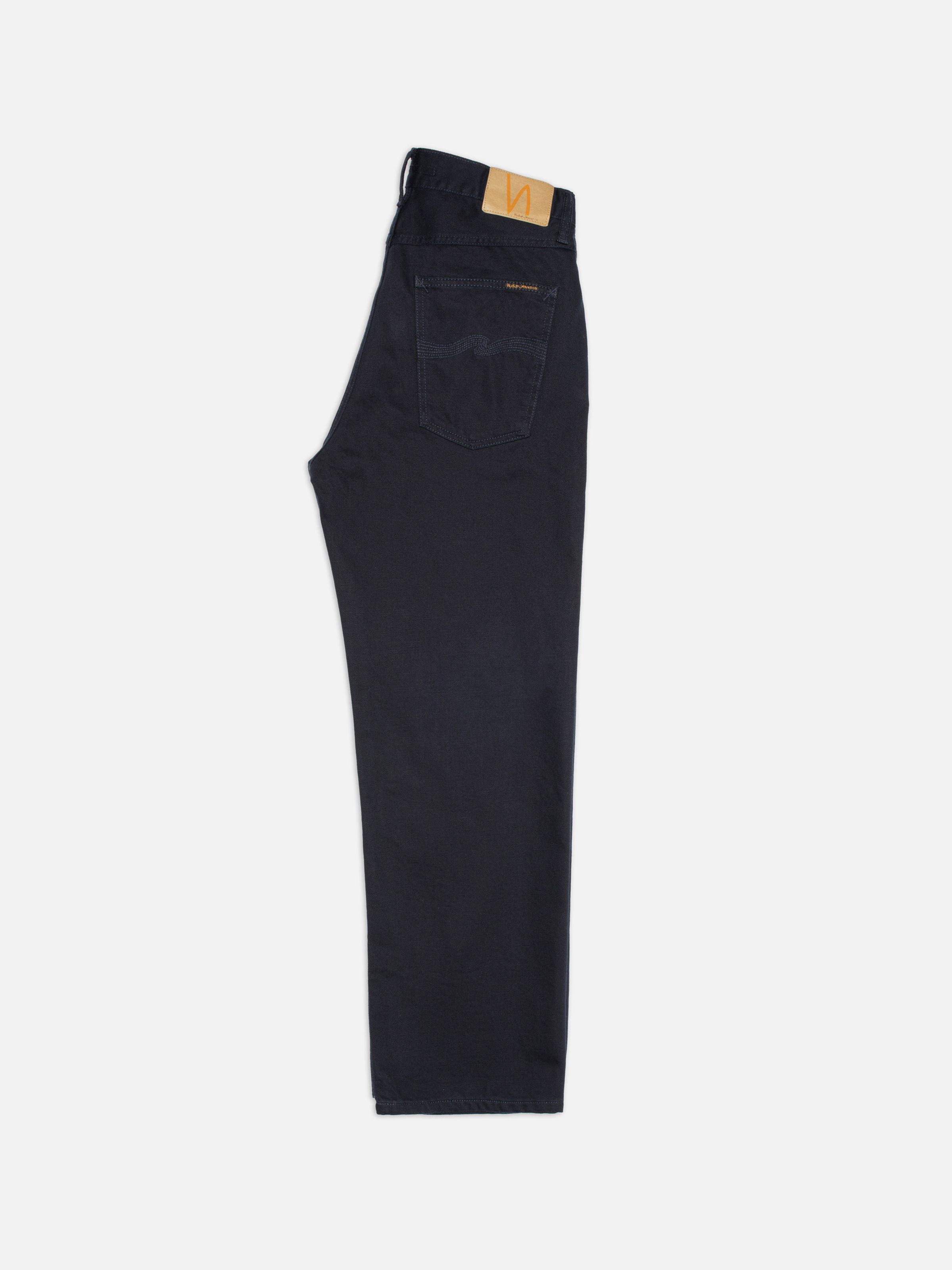 Nudie Jeans Tuff Tony Everblue, loose-fit wide-leg jeans in dark blue rigid denim shown from the side.