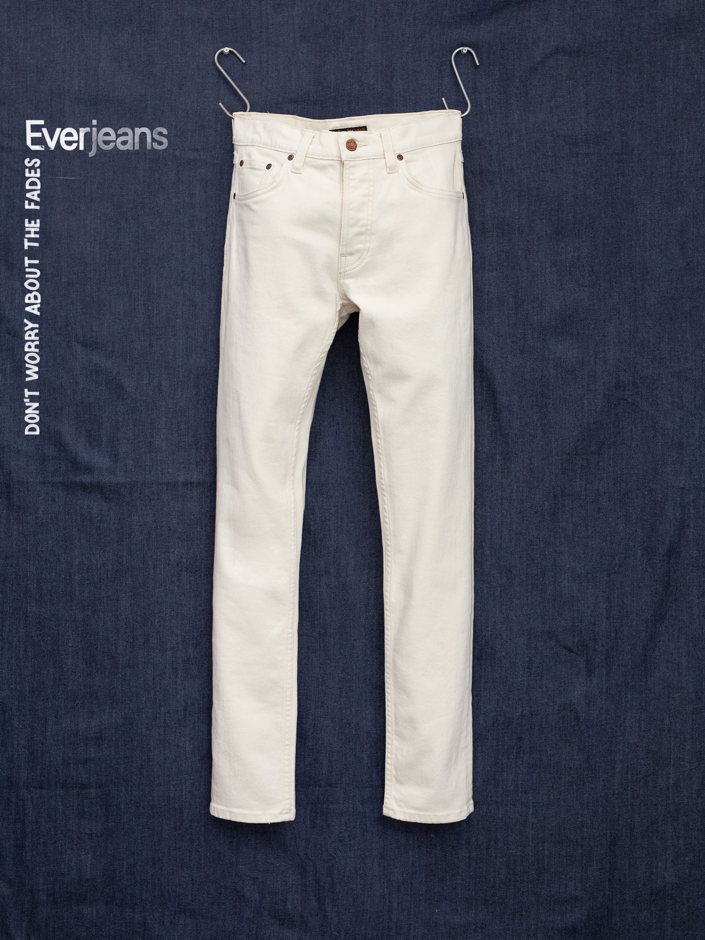 Nudie Jeans Solid Ollie Everivory, men's slim-fit jeans in ivory comfort stretch denim, front view flat lay.