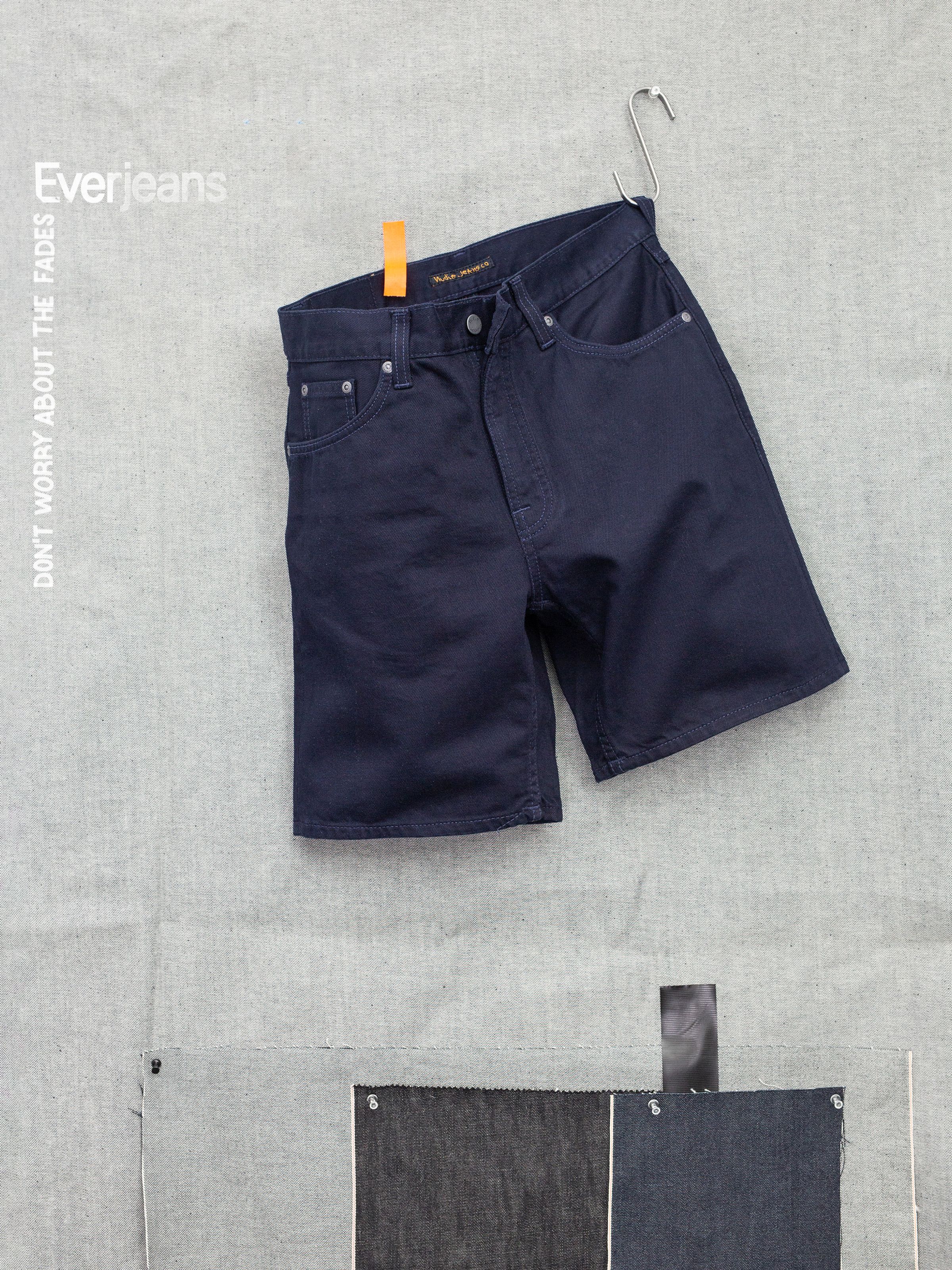 Nudie Jeans Seth Shorts Everblue, wide-leg high-waist shorts in dark blue rigid denim shown in a front flat lay.