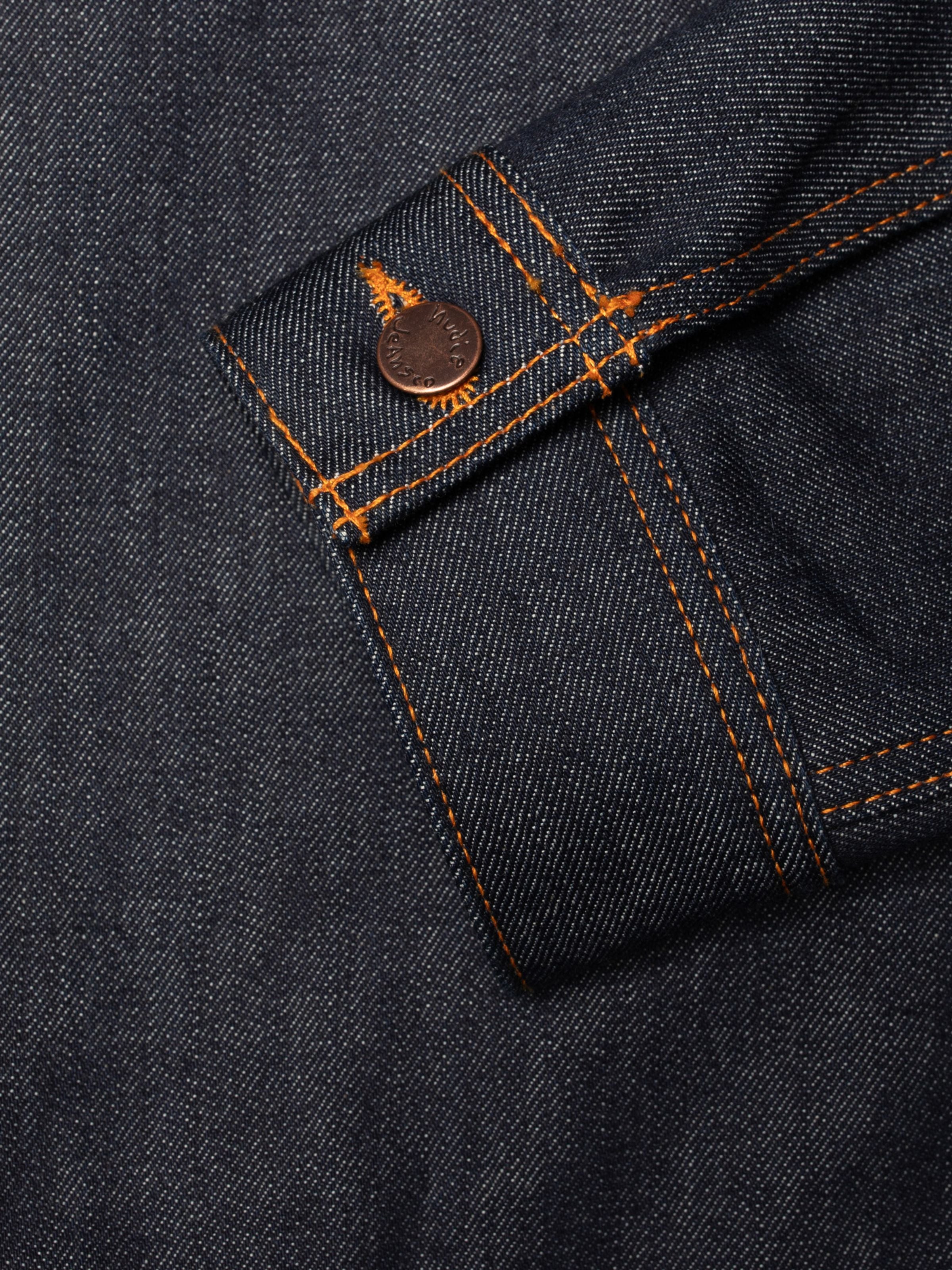 Nudie Jeans Conny Denim Jacket Dry One, close-up of the sleeve cuff showing the copper button and orange stitching.