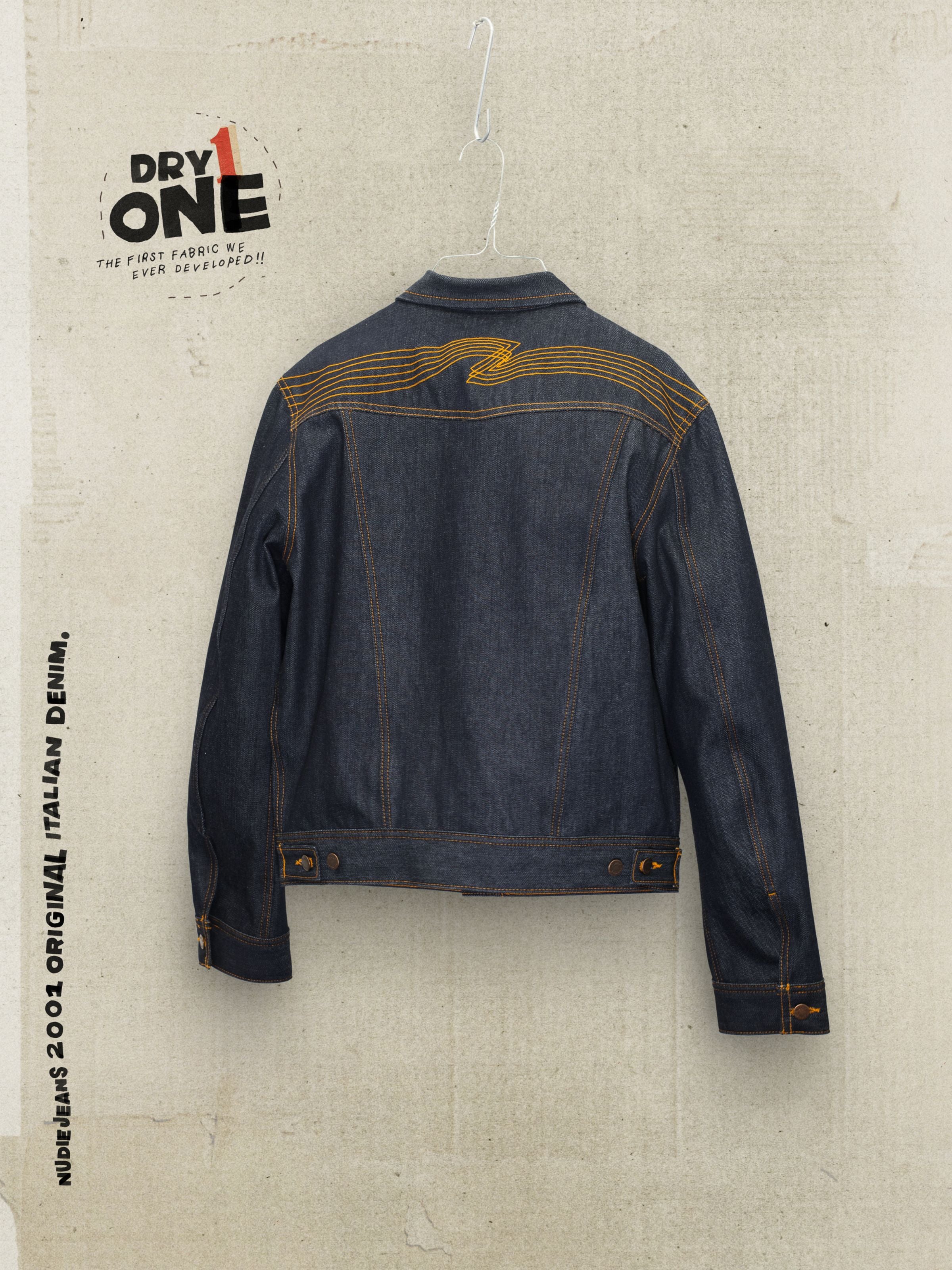 Nudie Jeans Conny Denim Jacket Dry One in indigo rigid organic cotton, featuring distinctive orange back yoke embroidery.