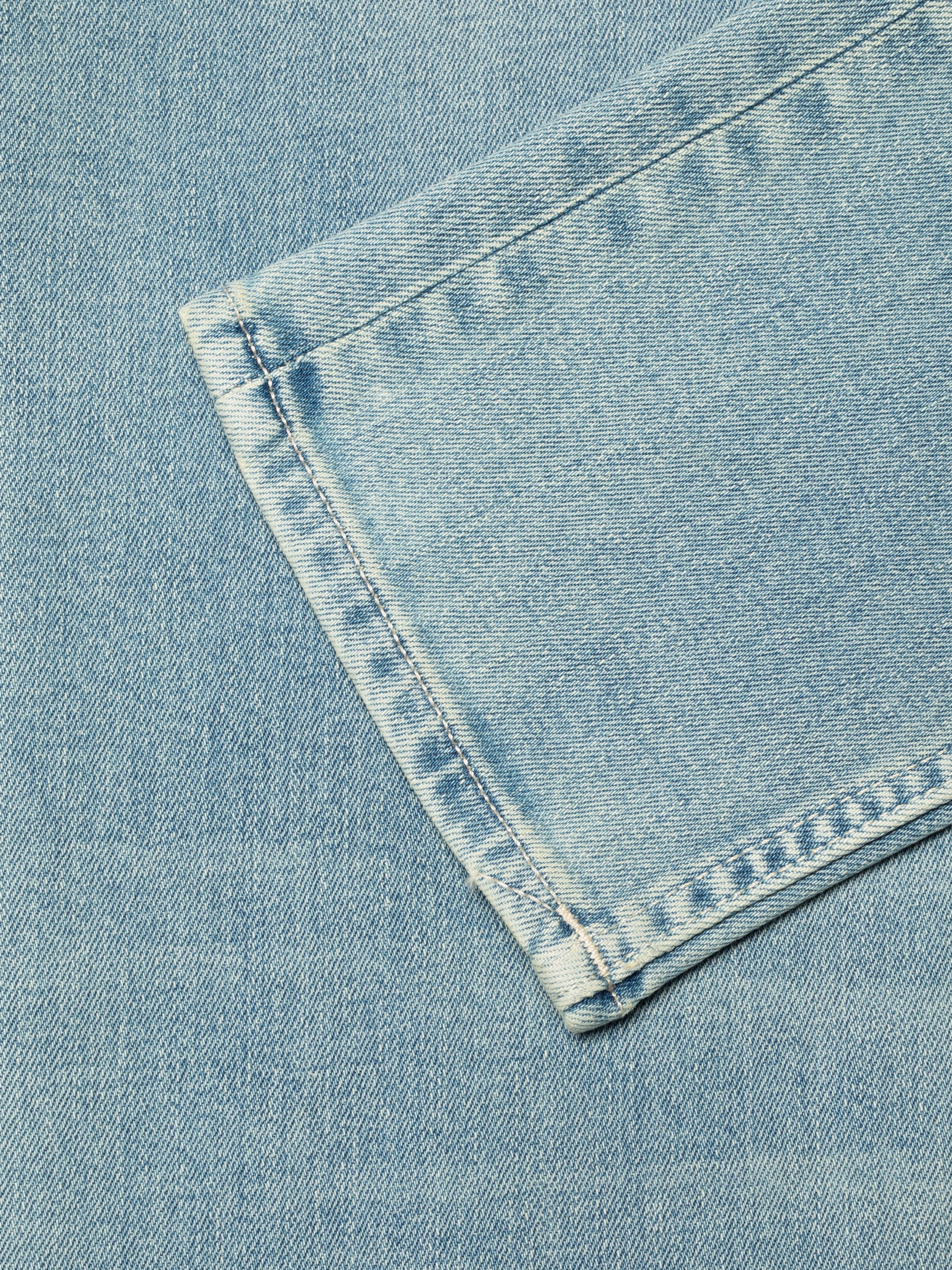 Nudie Jeans Lean Dean Shallow Sea, close-up of the leg opening showing the light blue denim and ecru thread.
