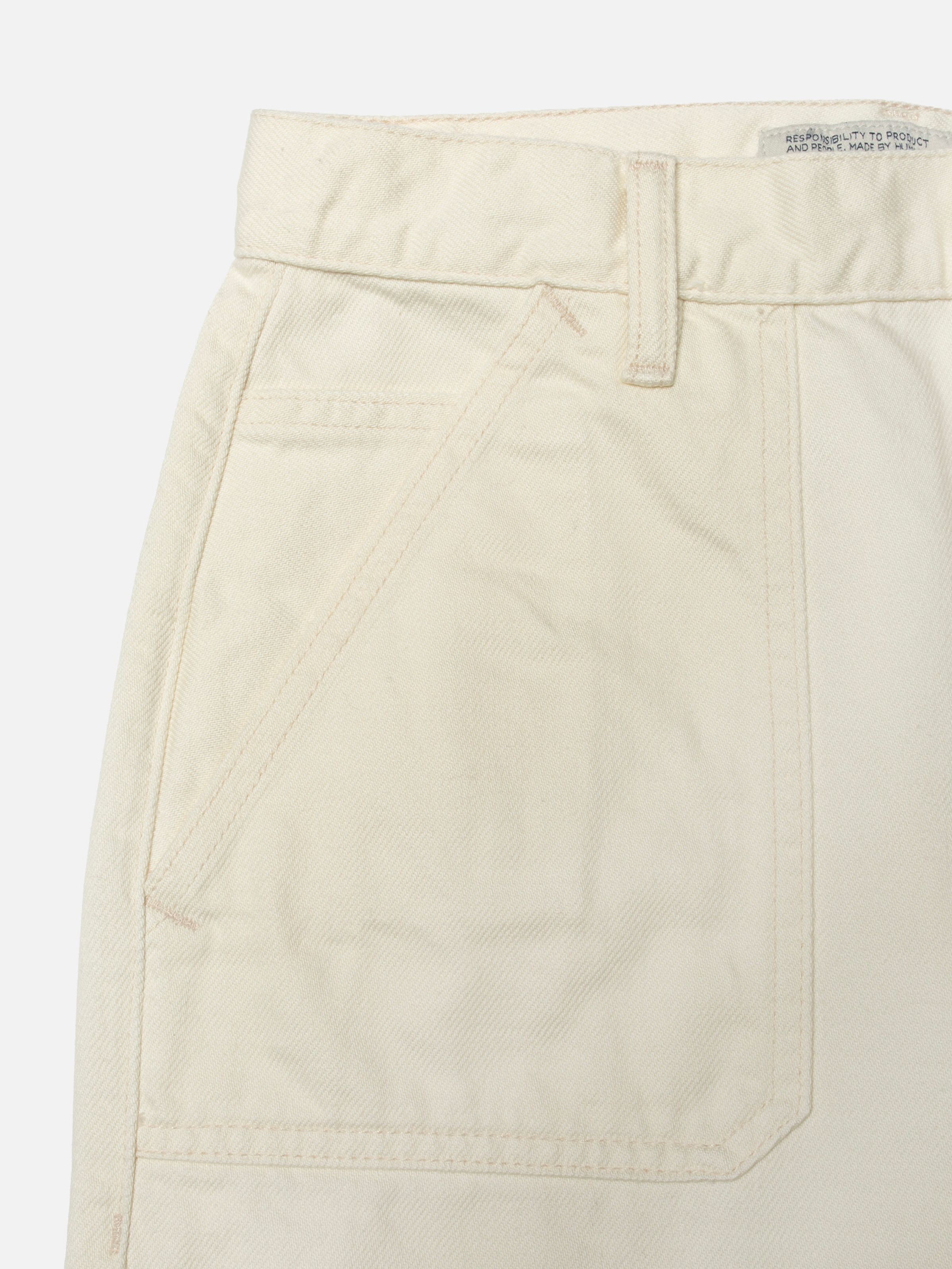 Nudie Jeans Asta Workwear Pants Ivory, close-up of the front pocket and waistband.