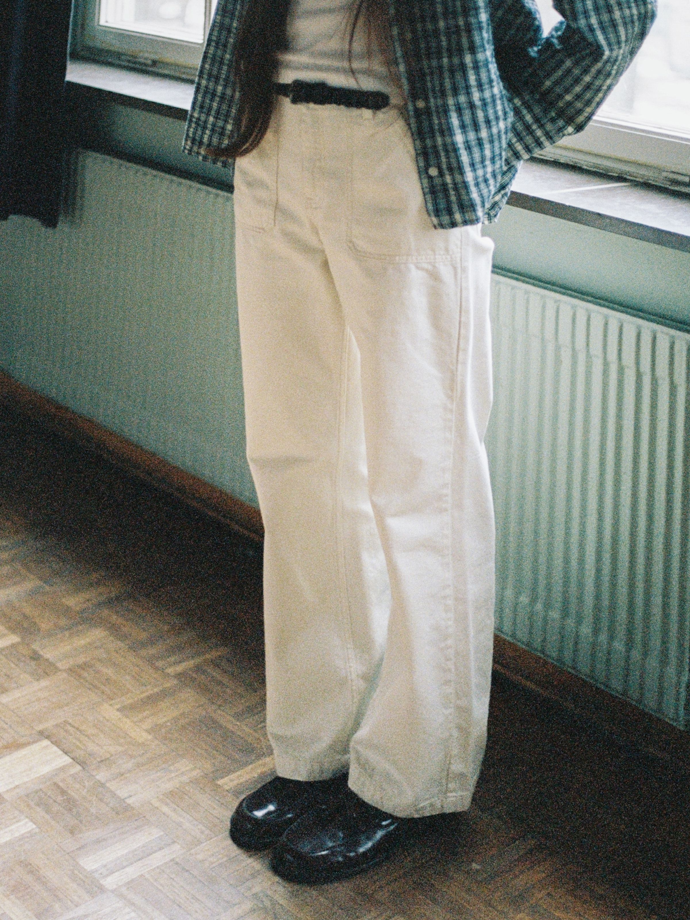 Nudie Jeans Asta Workwear Pants Ivory, women's wide-leg pants shown from the waist down on a model.