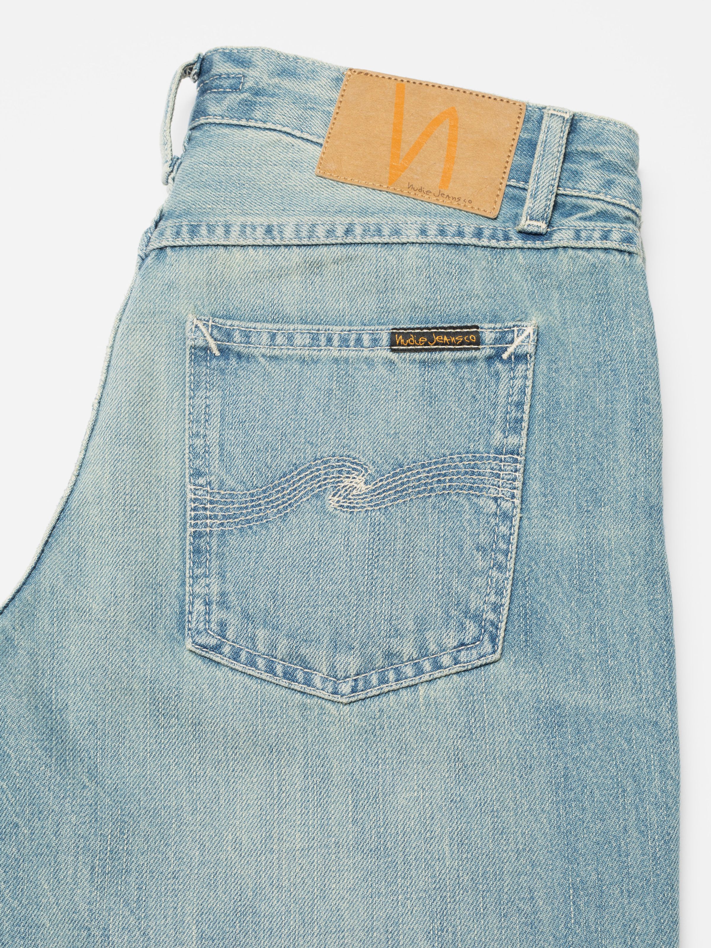 Nudie Jeans Wide Heidi Drift Wood, close-up of the back pocket with ecru embroidery and jacron patch.