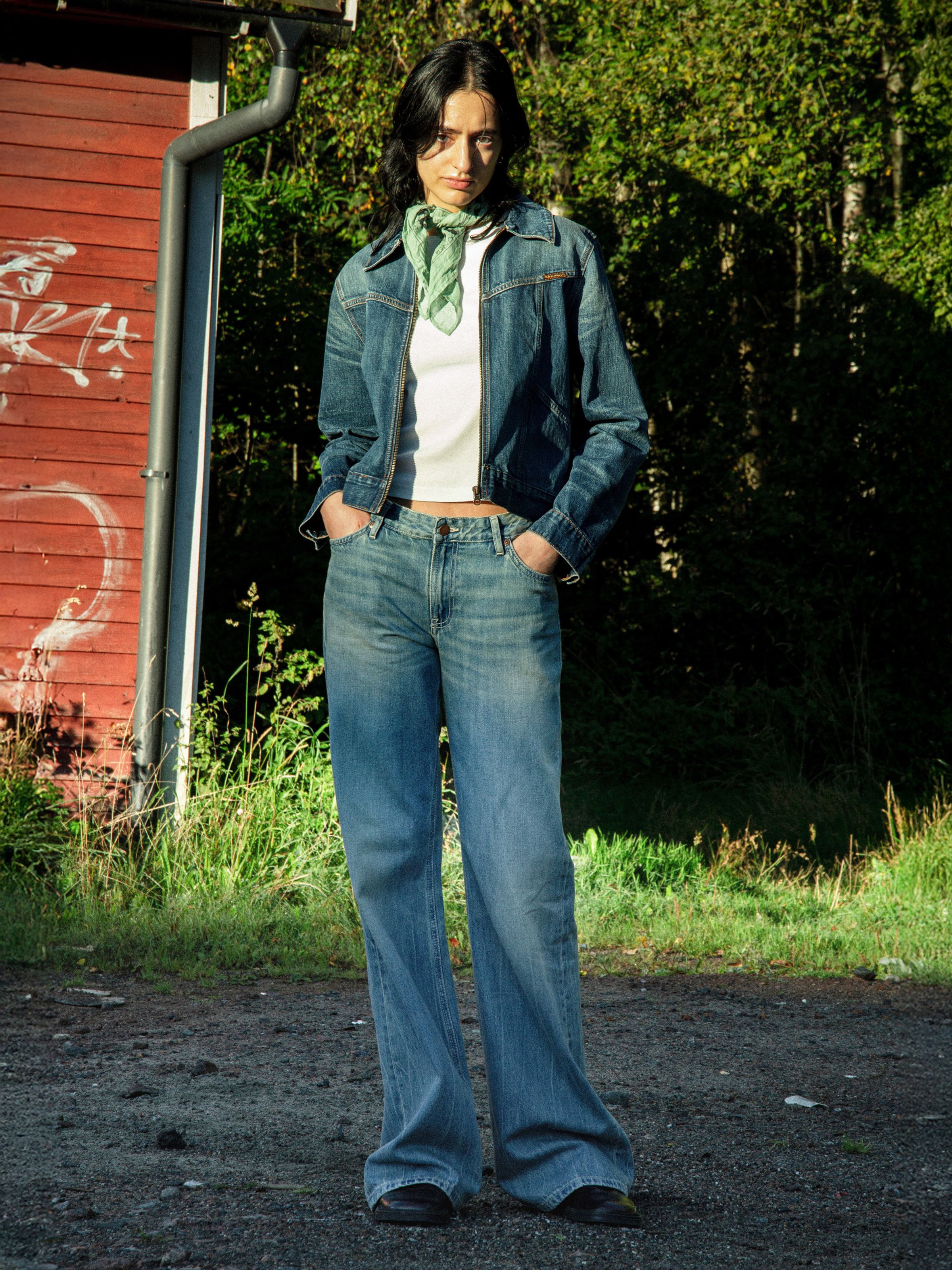 Nudie Jeans Wide Heidi Drift Wood, women's loose-fit wide-leg jeans shown on a model outdoors.