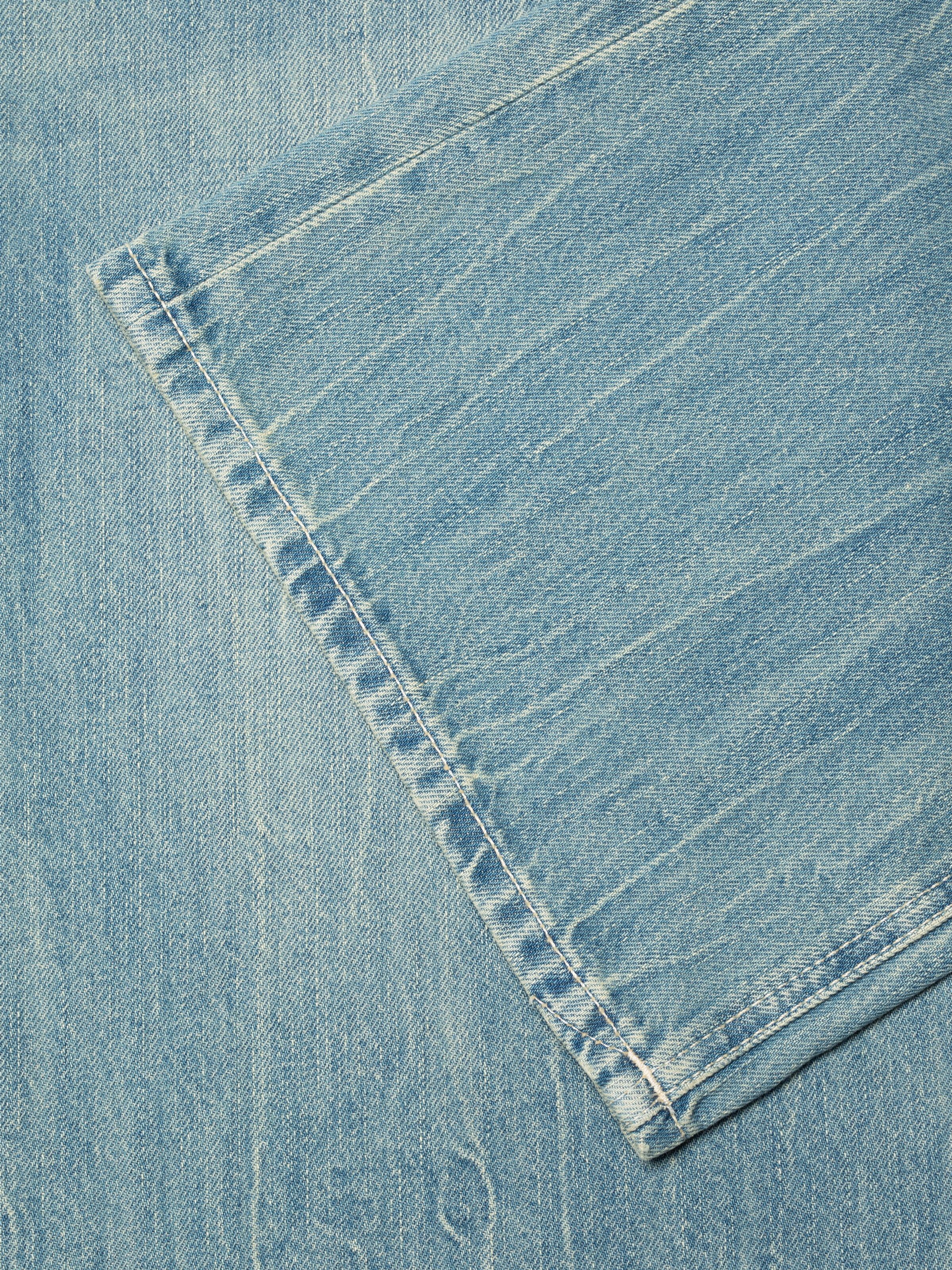 Nudie Jeans Wide Heidi Drift Wood, close-up of the light blue organic rigid denim and ecru stitching.