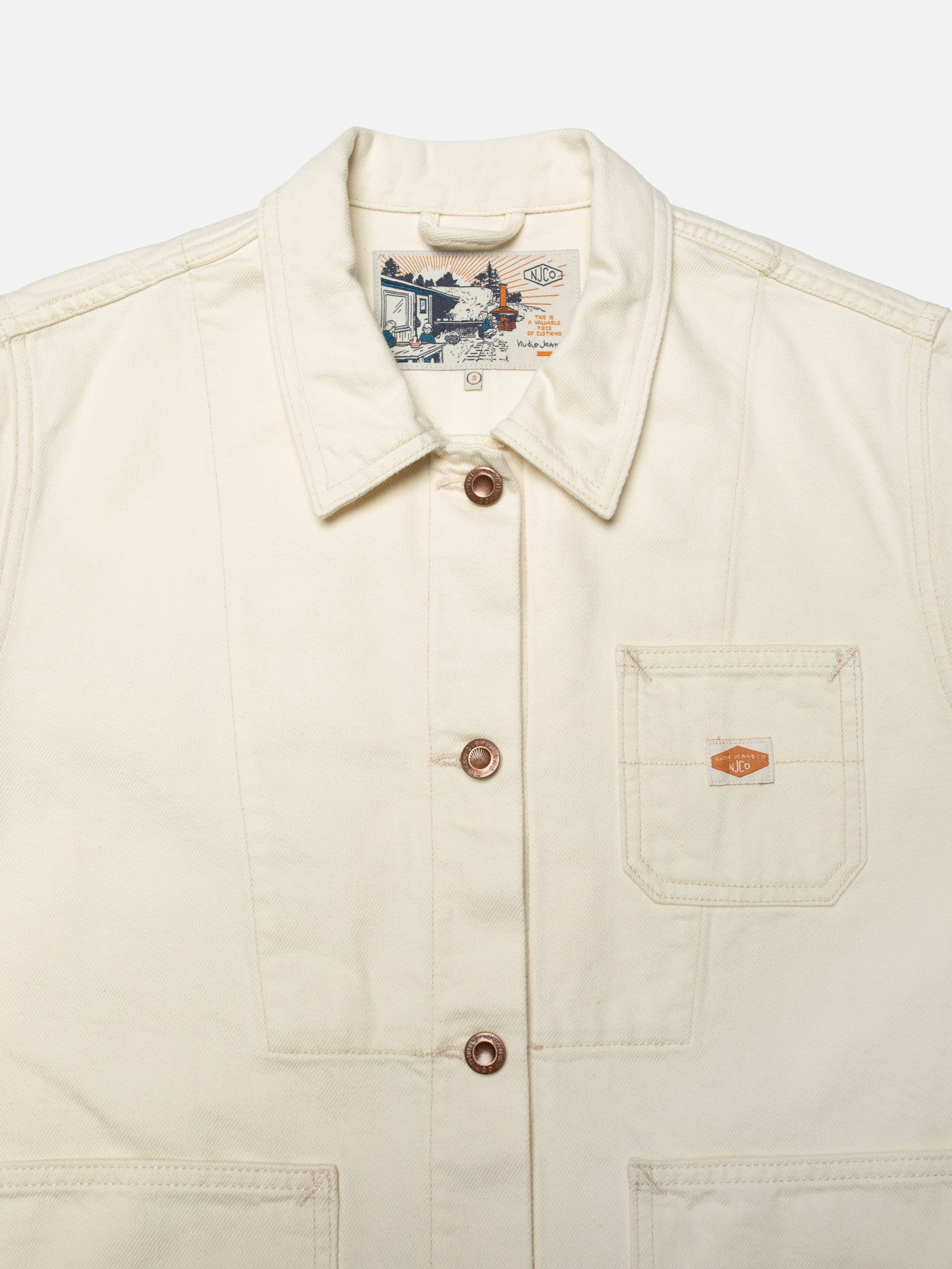 Nudie Jeans Ada Workwear Jacket Ivory, close-up of the front showing the collar, copper buttons, and chest pocket.