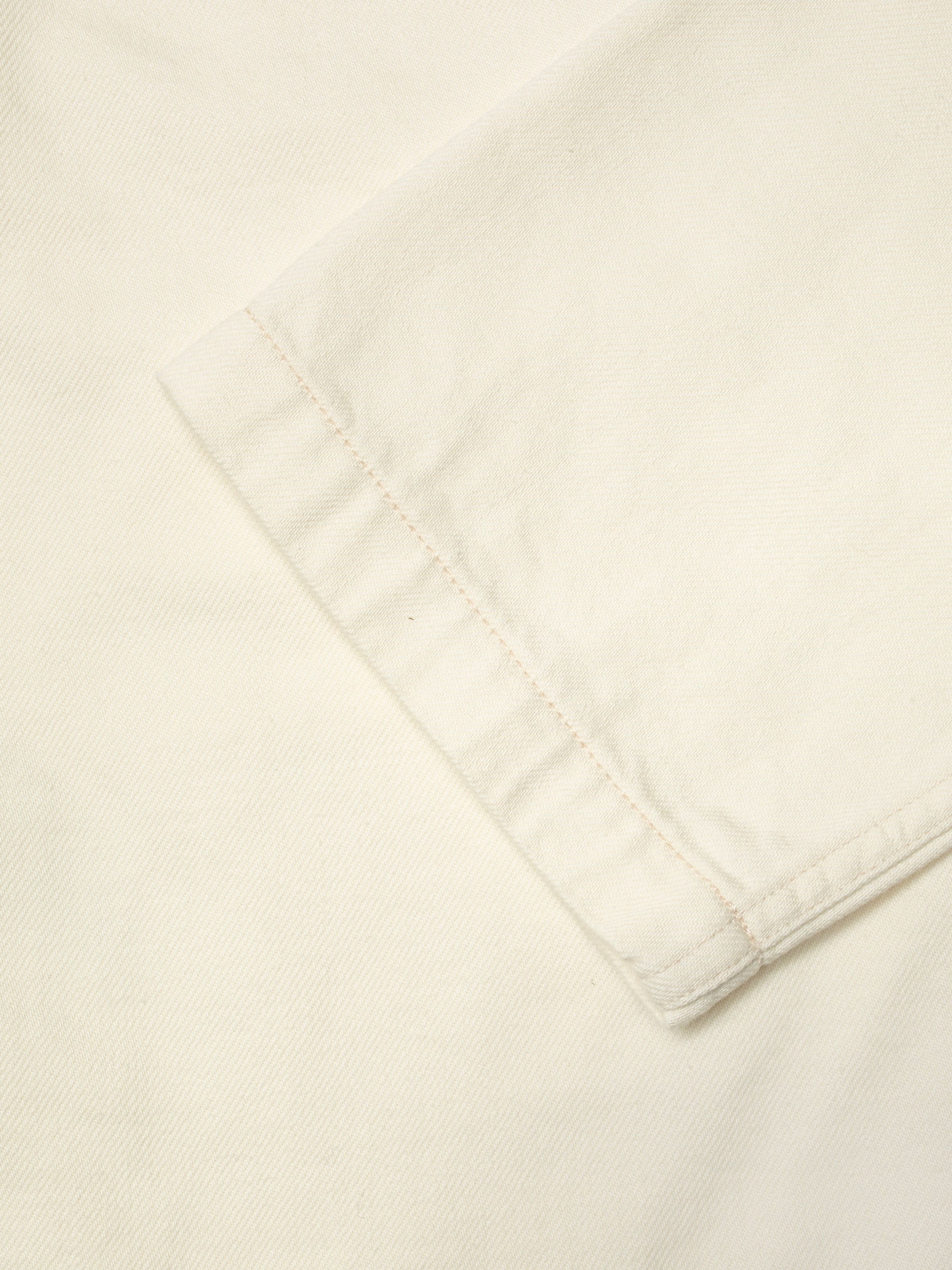 Nudie Jeans Ada Workwear Jacket Ivory, close-up of the sleeve cuff highlighting the ecru thread and denim texture.