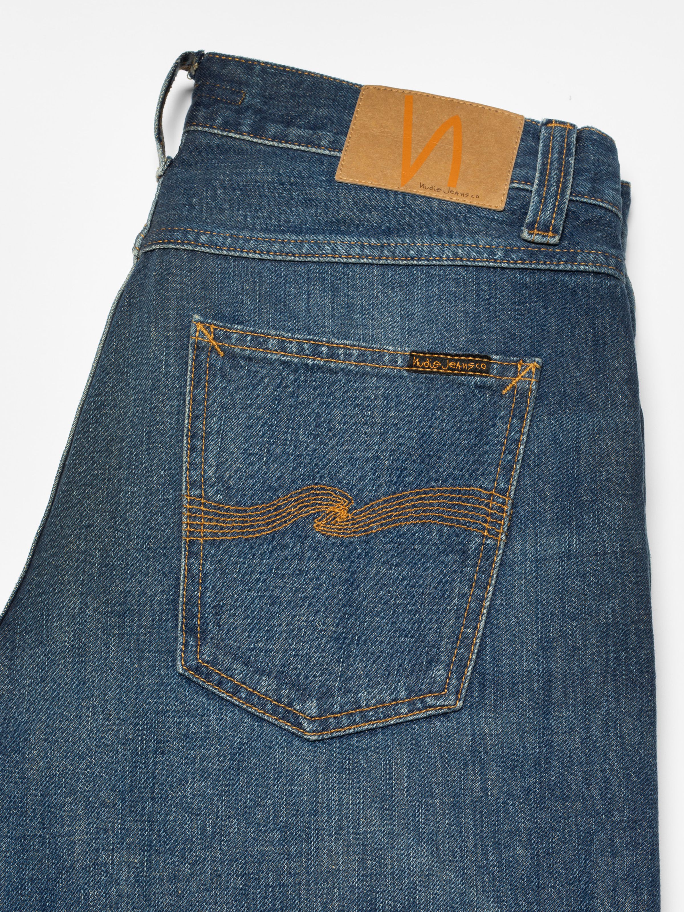 Nudie Jeans Steady Eddie II Indigo Dew, close-up of the back pocket with tobacco embroidery and Jacron patch.