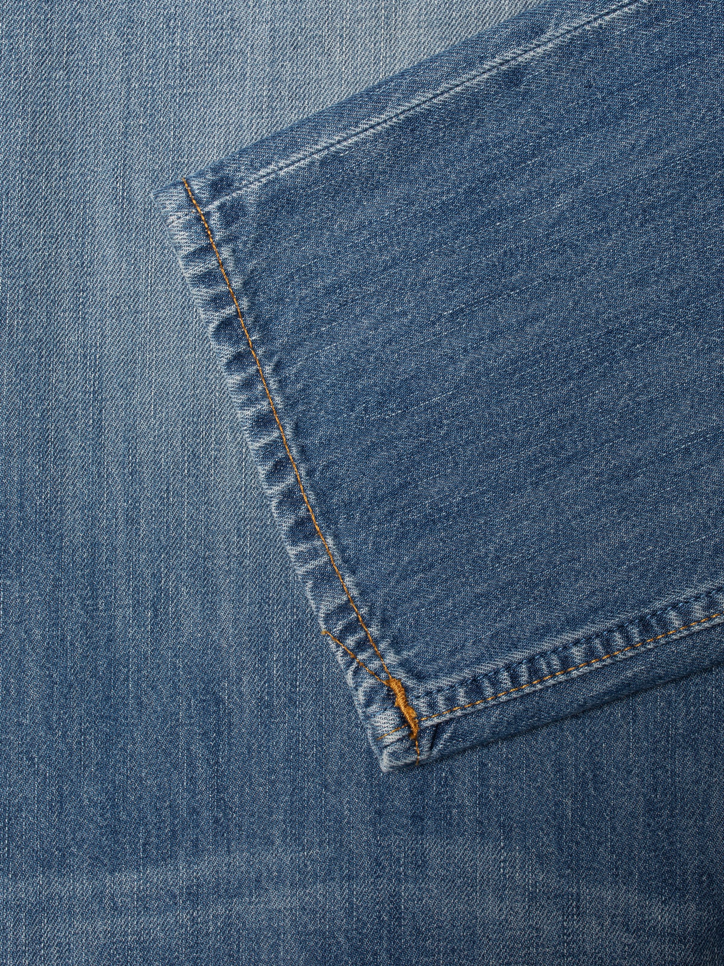 Nudie Jeans Rad Rufus Slow Drive, close-up of the leg opening with tobacco thread at the seams.